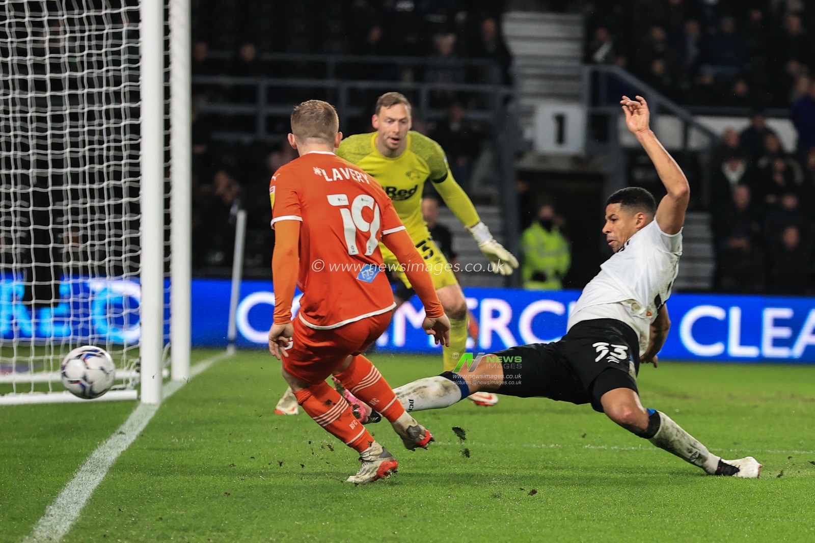 Curtis Davies #33 of Derby County puts Shayne Lavery #19 of Blackpoolâ€™s cross out for a corner