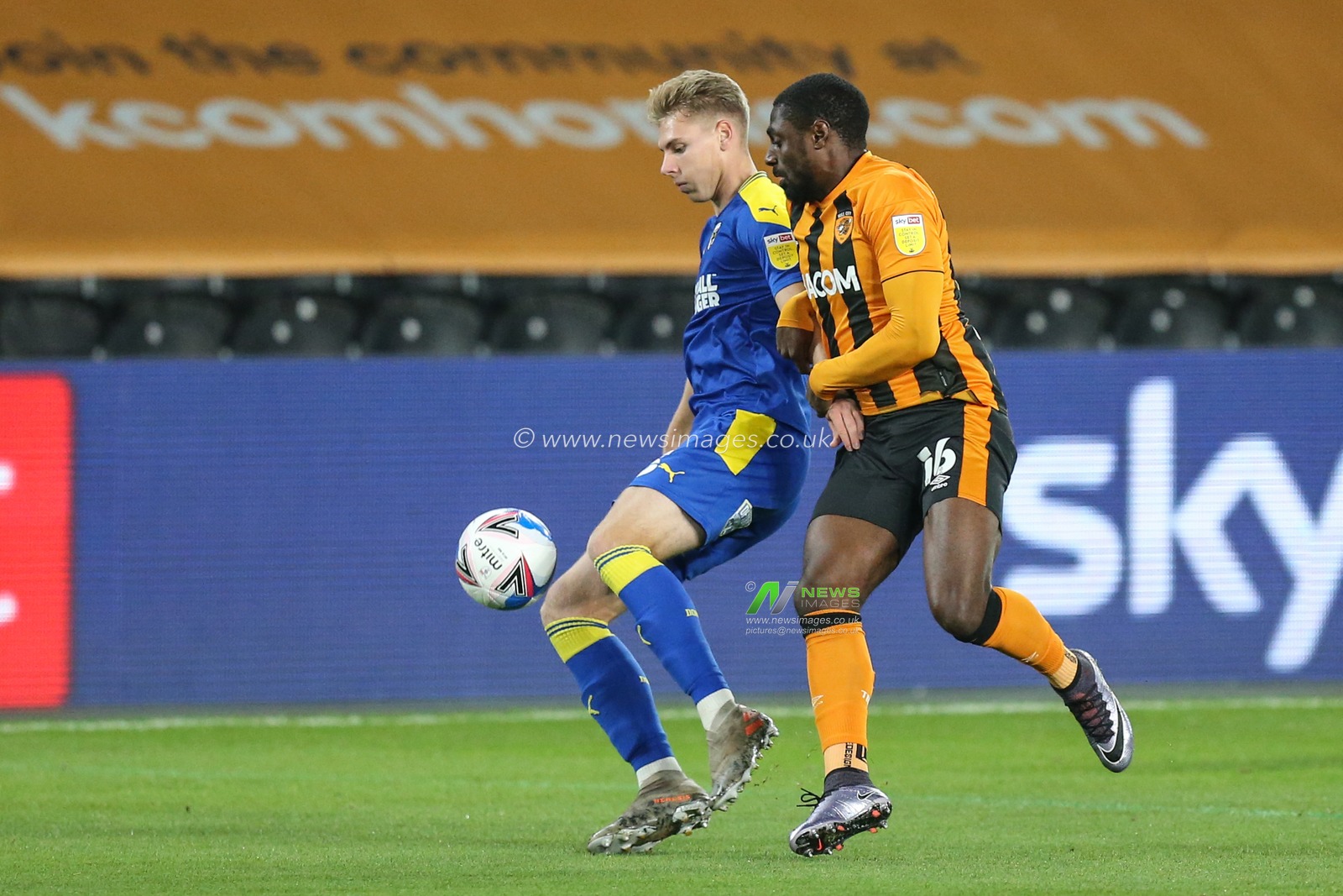 Daniel Csoka (3) of AFC Wimbledonand Hakeeb Adelakun (16) of Hull City challenge for the ball