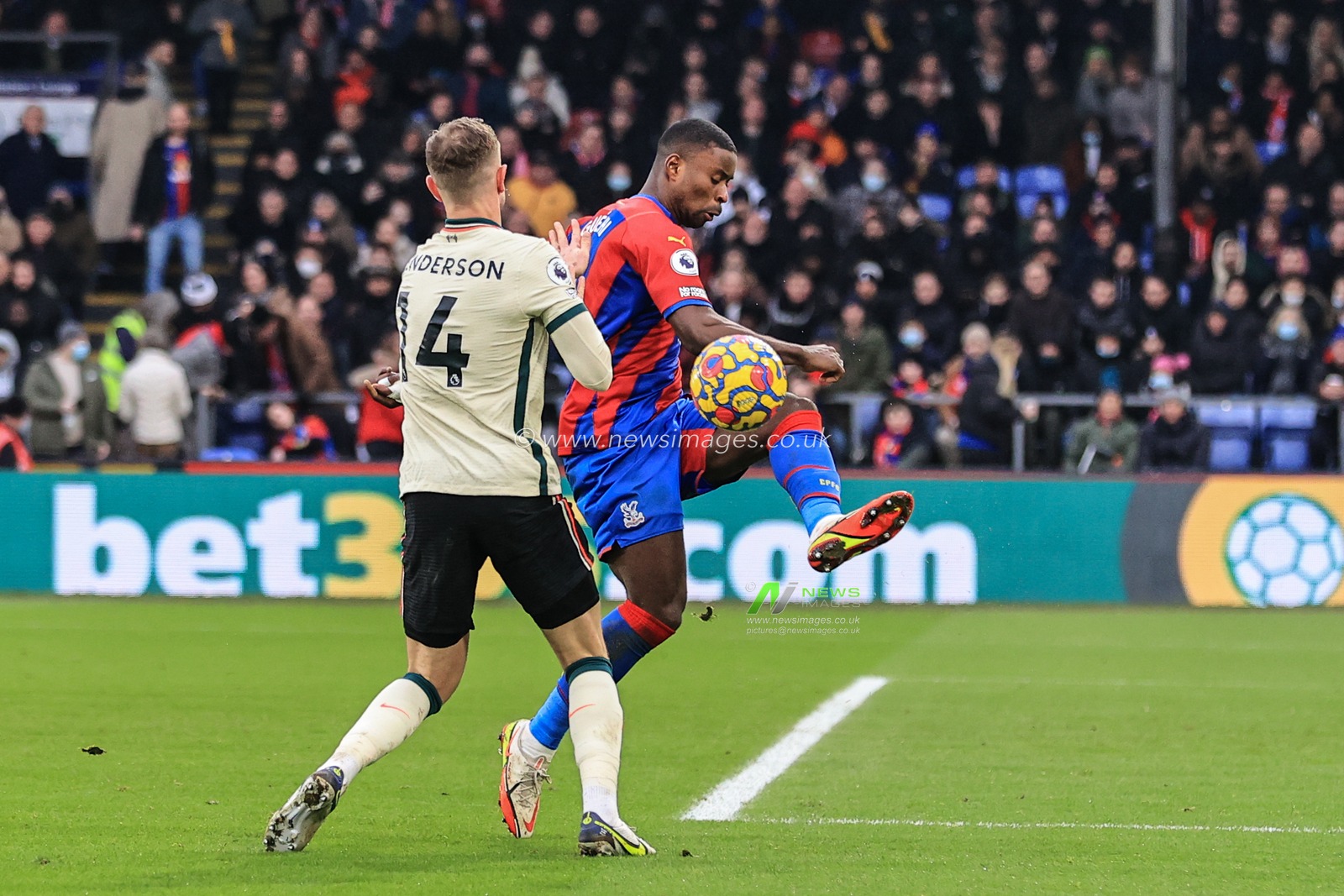 Marc Guehi #6 of Crystal Palace clears the ball from Jordan Henderson #14 of Liverpool
