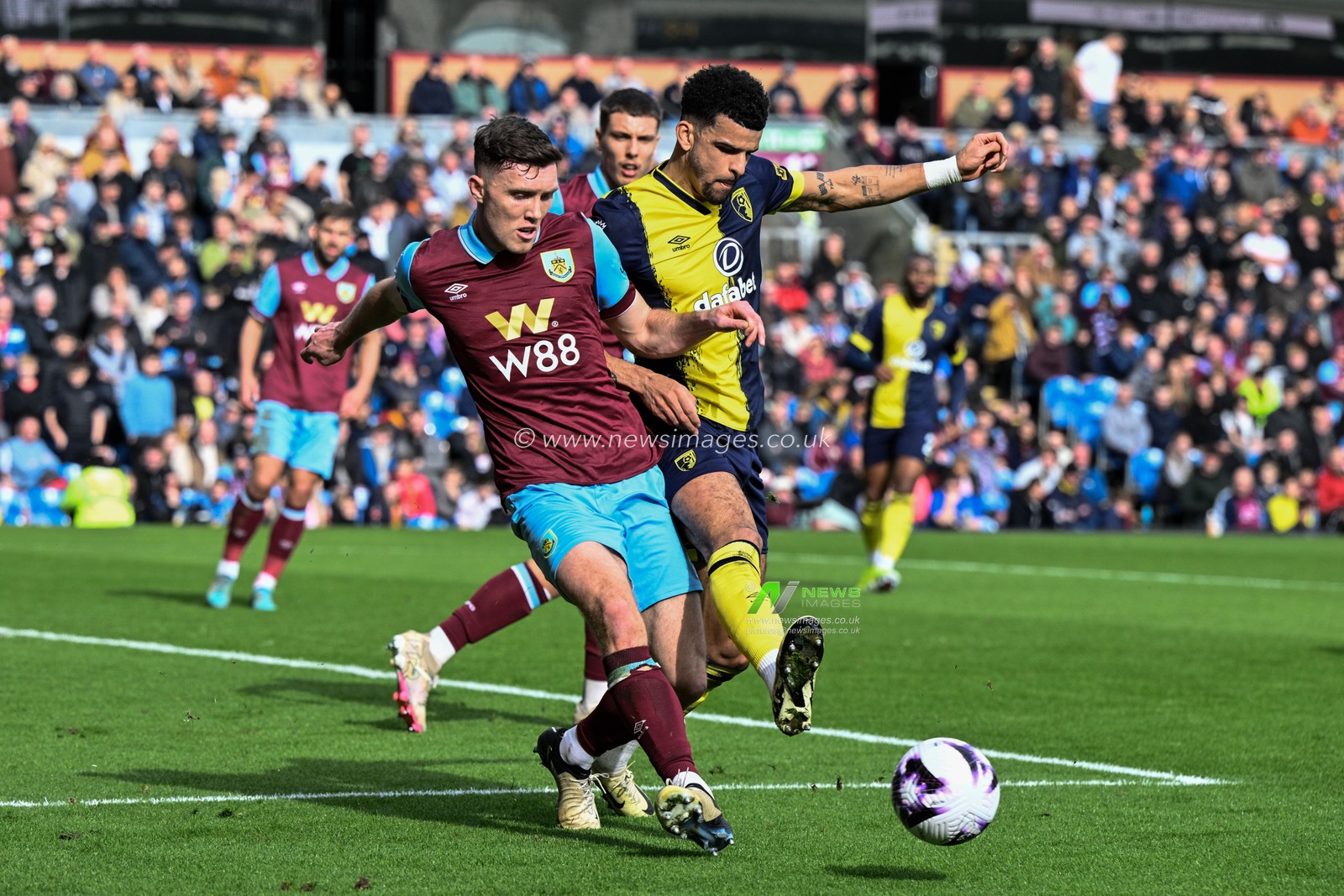 Dara O'Shea of Burnley passes the ball whilst getting pressured by Dominic Solanke of Bournemouth during the Premier League match Burnley vs Bournemouth at Turf Moor, Burnley, United Kingdom, 3rd March 2024

(Photo by Cody Froggatt/News Images)