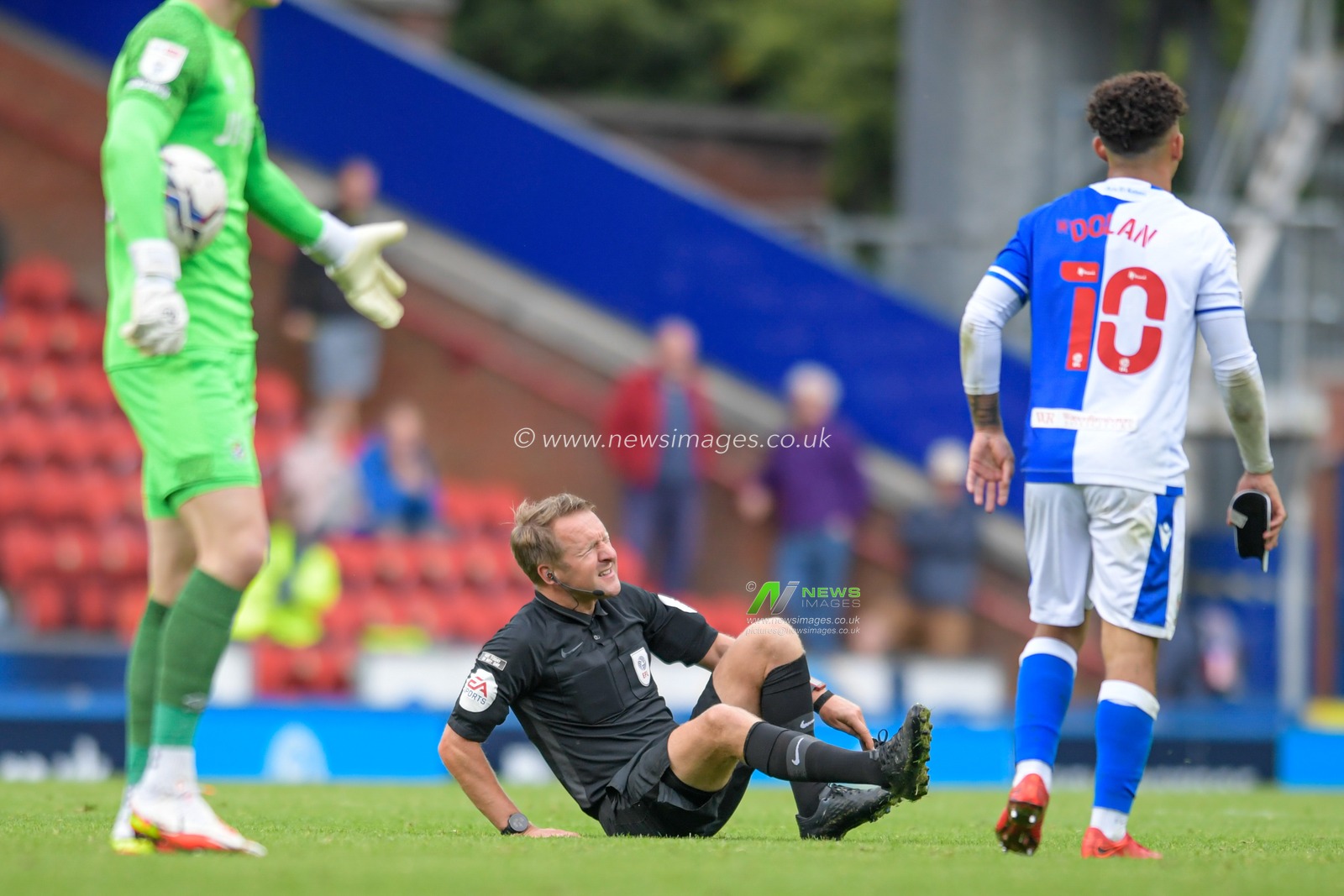 Referee Oliver Langford goes down on the pitch with an injury