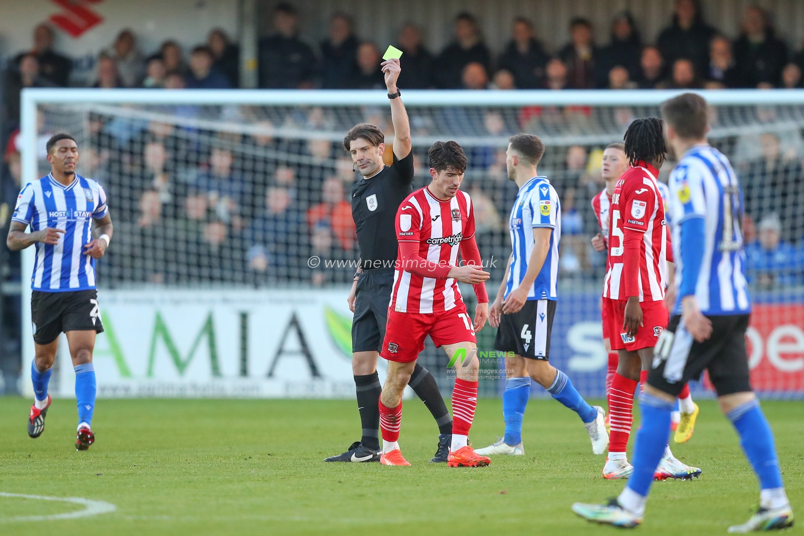 Josh Key #12 of Exeter City receives a yellow card from referee Neil Hair during the Sky Bet League 1 match Exeter City vs Sheffield Wednesday at St James' Park, Exeter, United Kingdom, 10th December 2022

(Photo by Gareth Evans/News Images)
