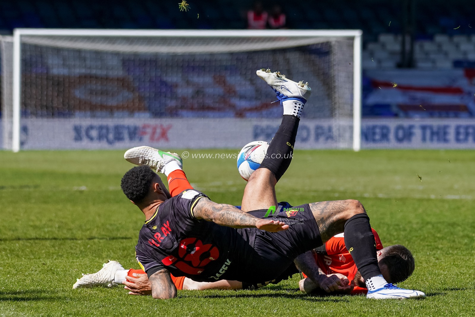 Andre Gray #18 of Watford tangles with Sonny Bradley #5 of Luton Town