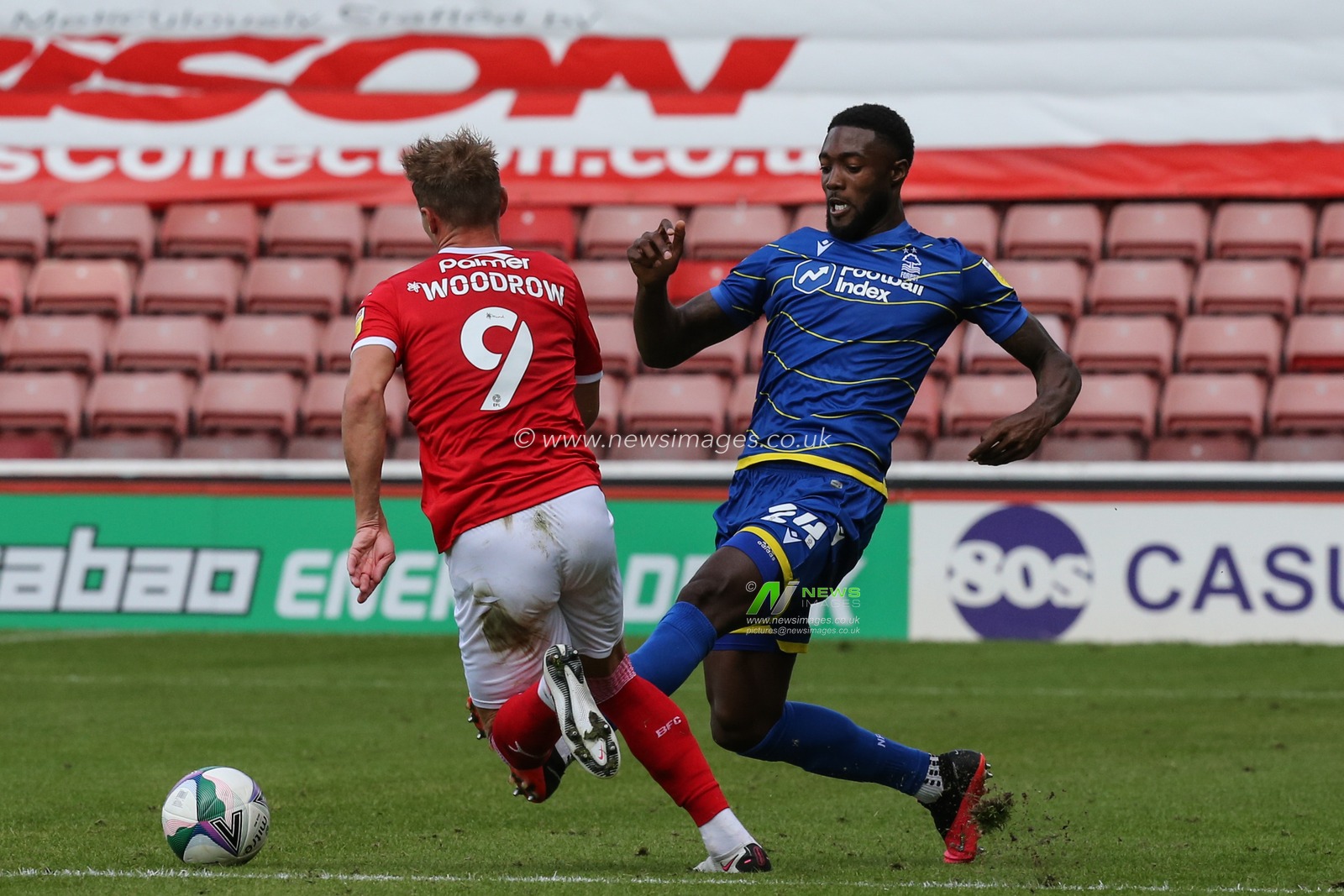 Cauley Woodrow (9) of Barnsley looks to get past Tyler Blackett (24) of Nottingham Forest