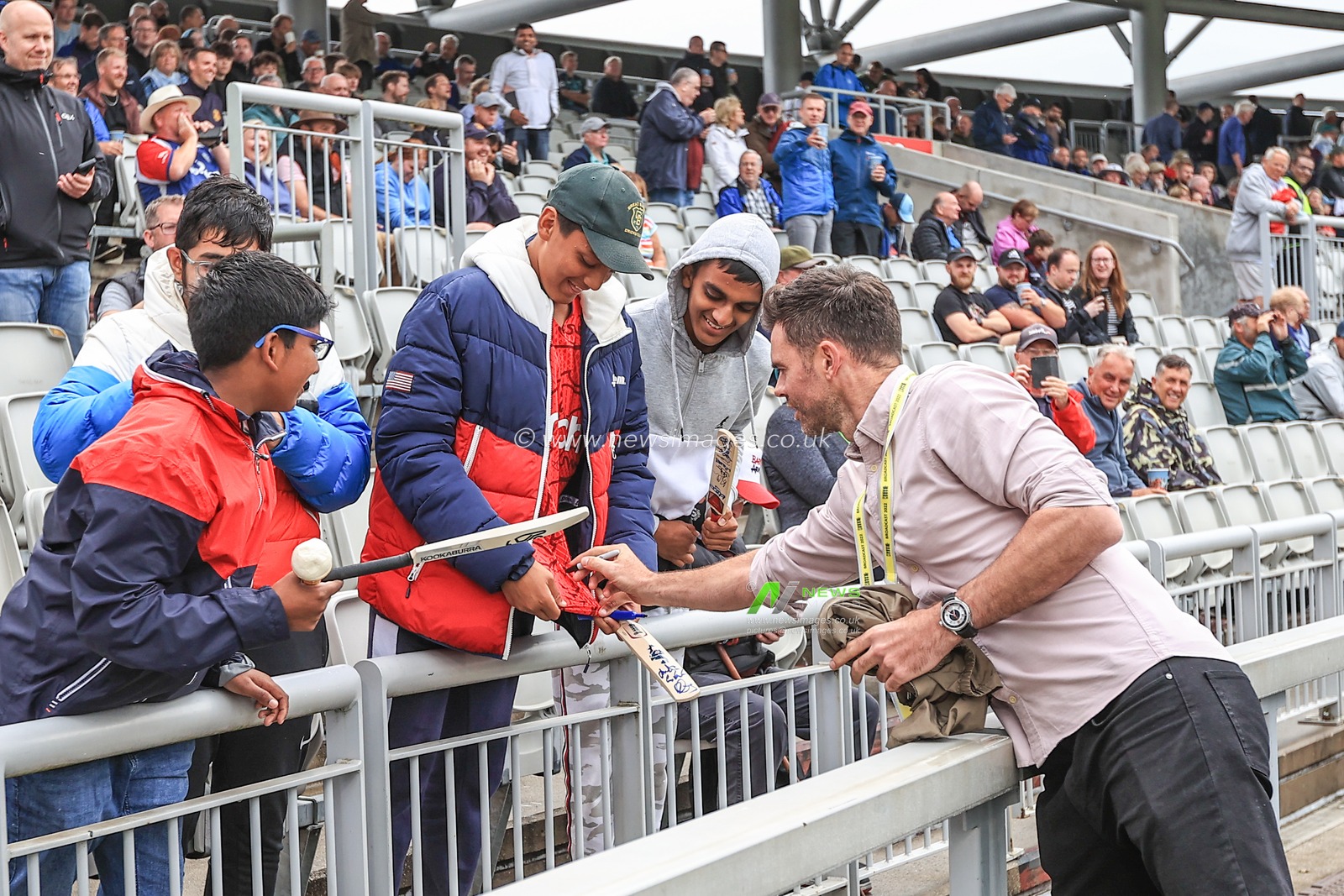 James Anderson of England sings a fans England shirt