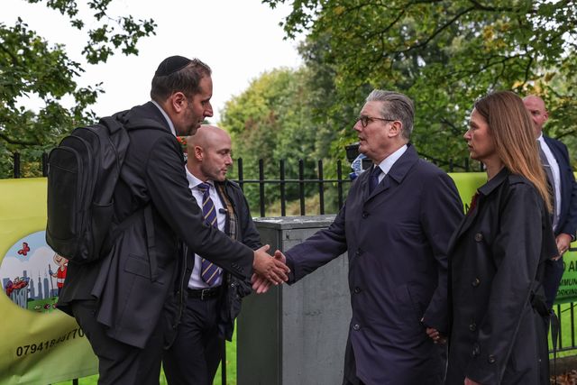 Victoria, Lady Starmer holds her husband Sir Keir Starmer, Prime Minister of the United Kingdom of Great Britain and Northern Ireland’s hand as he shakes hands with a member of the local community during the Manchester synagogue terror attack day 2 at Heaton Park Shul, Manchester, United Kingdom, 3rd October 2025

(Photo by Mark Cosgrove/News Images)