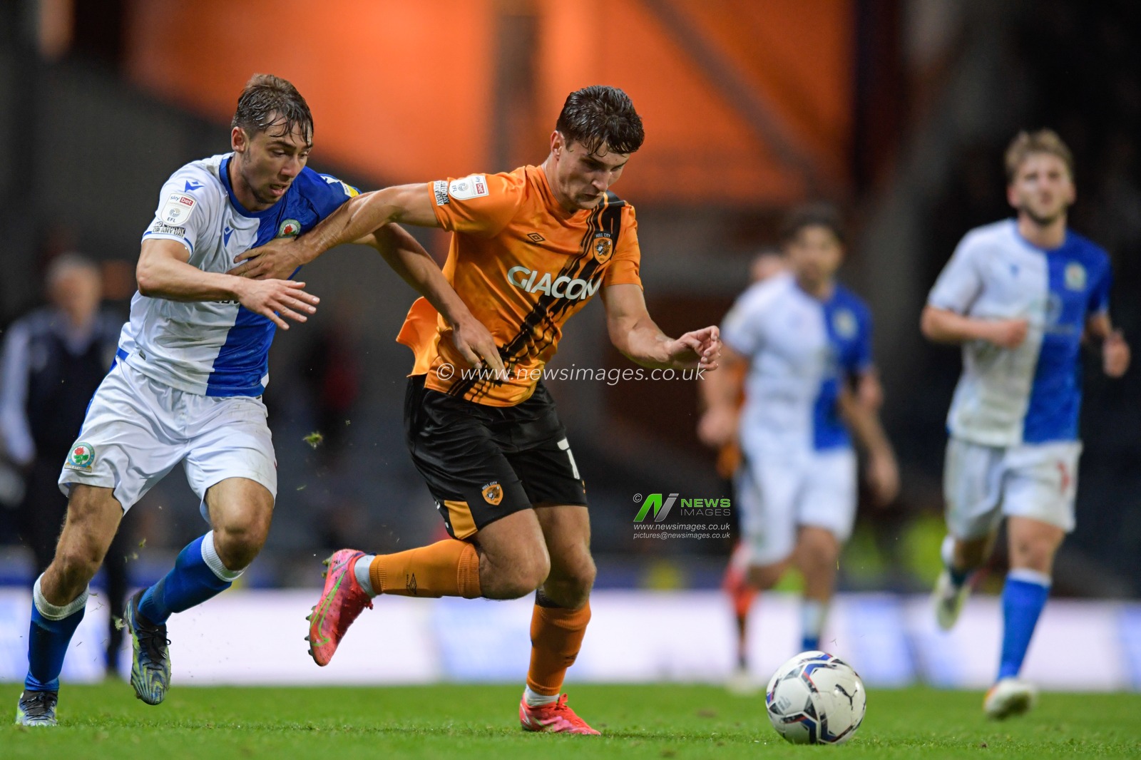 Ryan Longman #16 of Hull City holds off the tackle attempt from Harry Pickering #3 of Blackburn Rovers