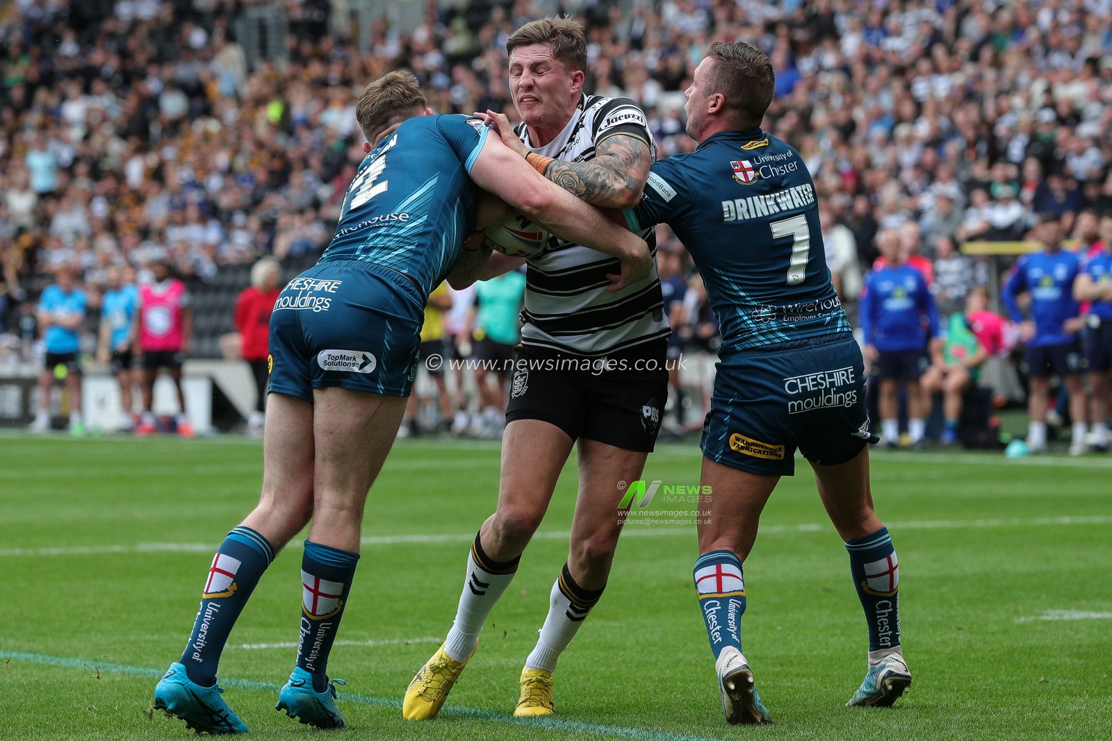 Liam Sutcliffe #4 of Hull FC is tackled by Matty Nicholson #12 of Warrington Wolves and Josh Drinkwater #7 of Warrington Wolves during the Betfred Super League Round 23 match Hull FC vs Warrington Wolves at MKM Stadium, Hull, United Kingdom, 26th August 2023

(Photo by James Heaton/News Images)