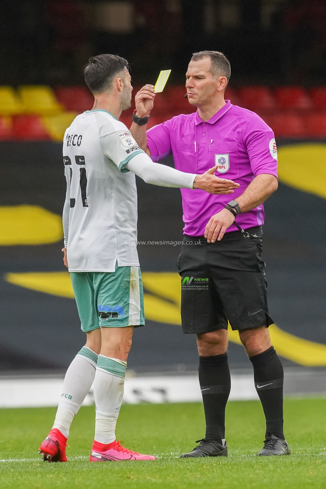 Diego Rico (21) of Bournemouth receives a yellow card from referee Tim Robinson