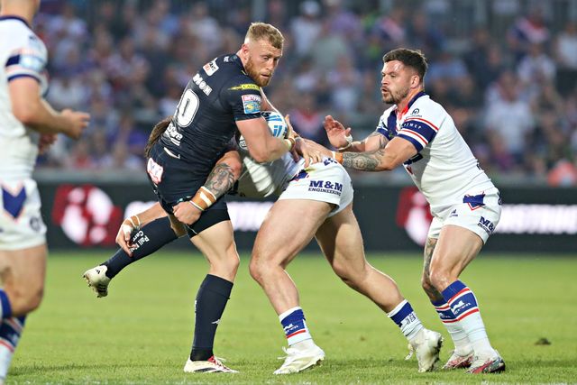 Jack Croft of Wakefield Trinity tackles Luke Thompson of Wigan Warriors during the Betfred Super League round 15 match Wakefield Trinity vs Wigan Warriors at DIY Kitchens Stadium, Wakefield, United Kingdom, 20th June 2025(Photo by Sam Eaden/News Images)