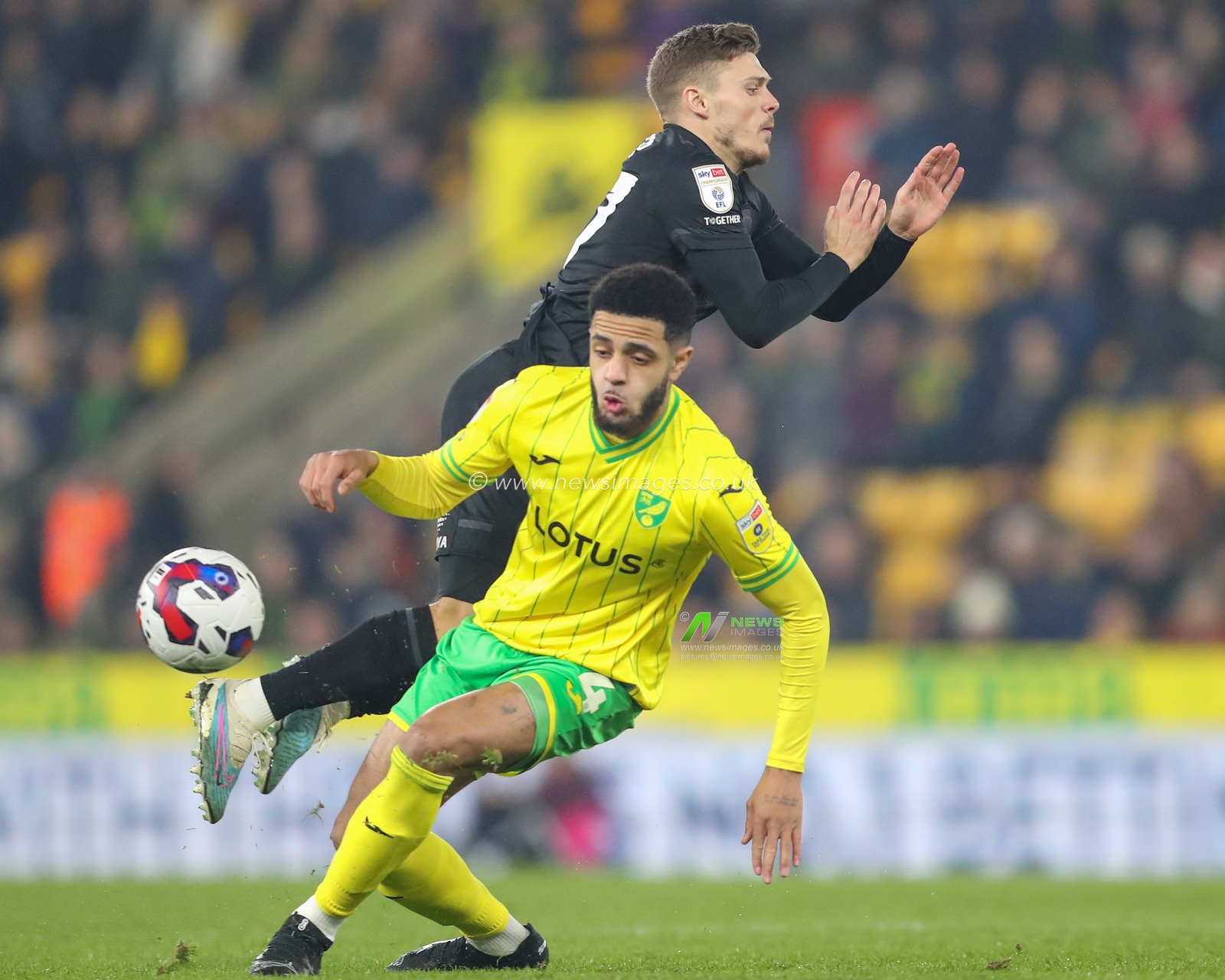 Regan Slater #27 of Hull City is tackled by Andrew Omobamidele #4 of Noriwch City during the Sky Bet Championship match Norwich City vs Hull City at Carrow Road, Norwich, United Kingdom, 14th February 2023

(Photo by Gareth Evans/News Images)