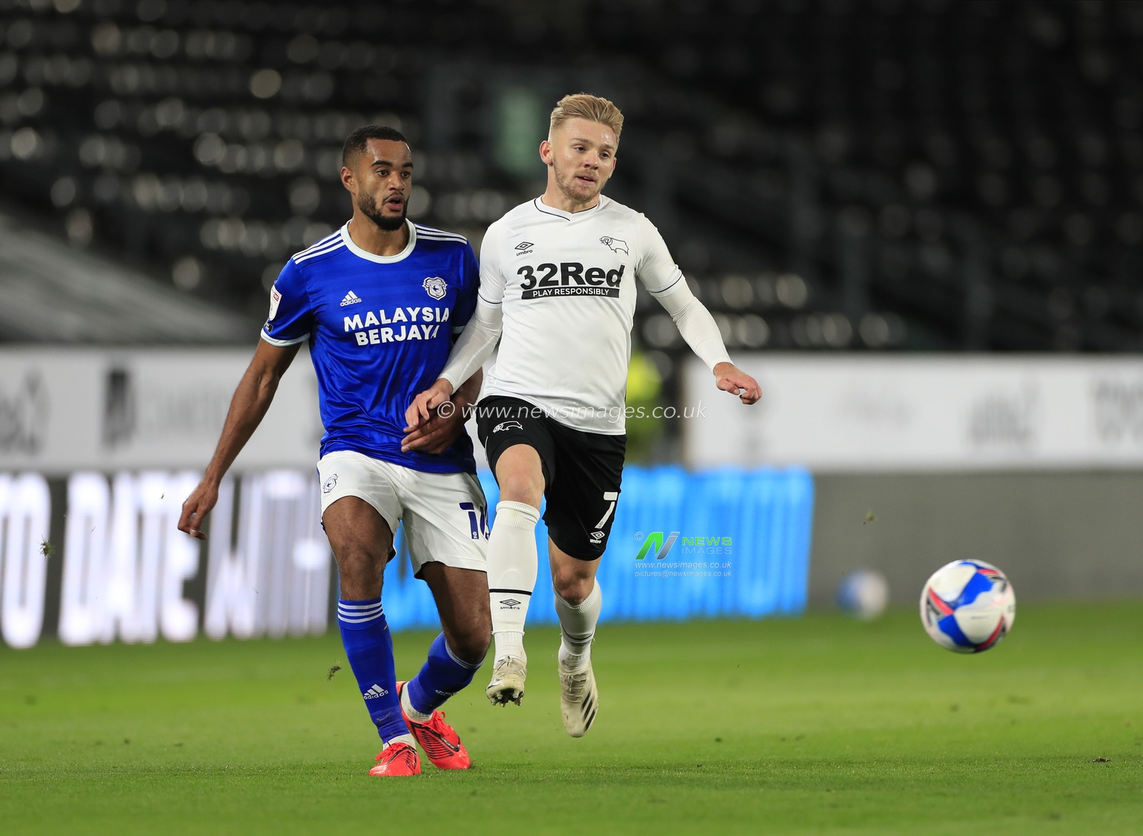 Curtis Nelson (16) of Cardiff City passes the ball away from Kamil Jozwiak (7) of Derby County