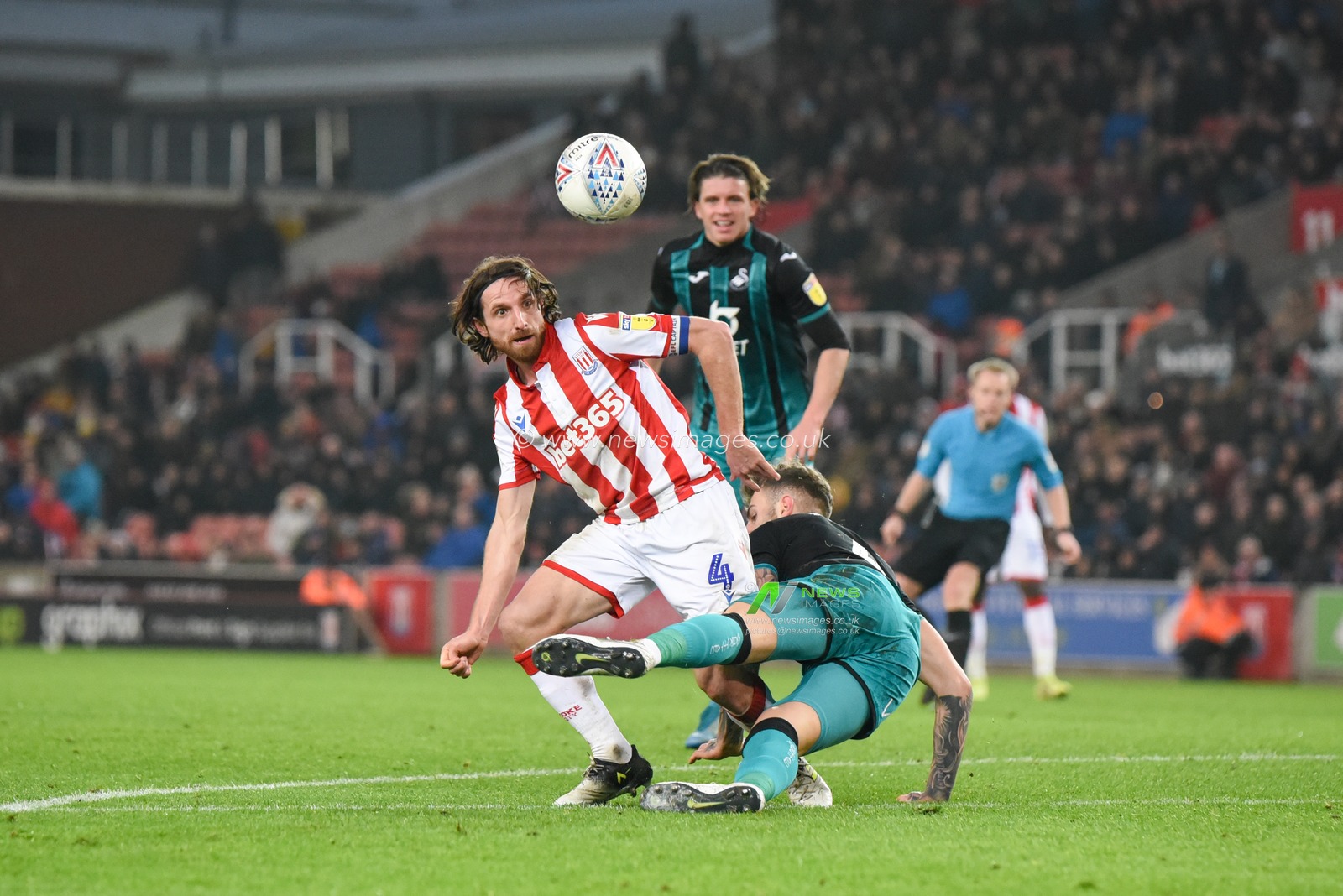 25th January 2020, Bet365 Stadium, Stoke-on-Trent, England; Sky Bet Championship, Stoke City v Swansea City : Joe Allen (4) of Stoke City heads the ball with Joe Rodon (4) of Swansea City sliding in