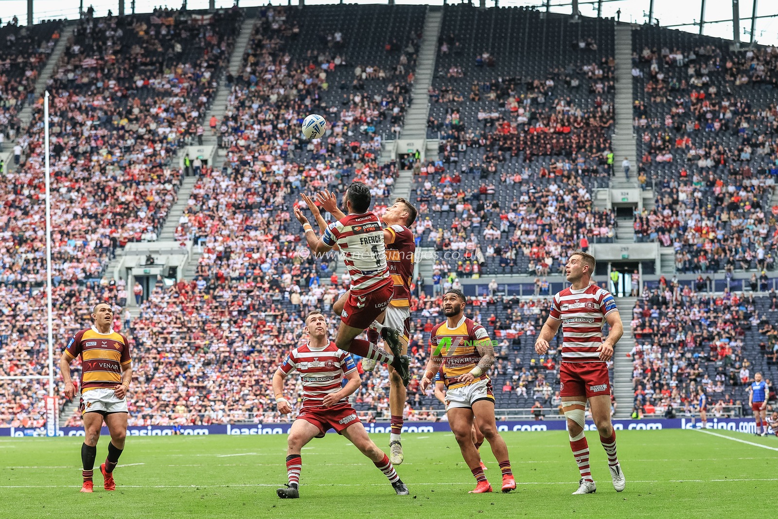 Bevan French #1 of Wigan Warriors wins the high-ball from Innes Senior #25 of Huddersfield Giants