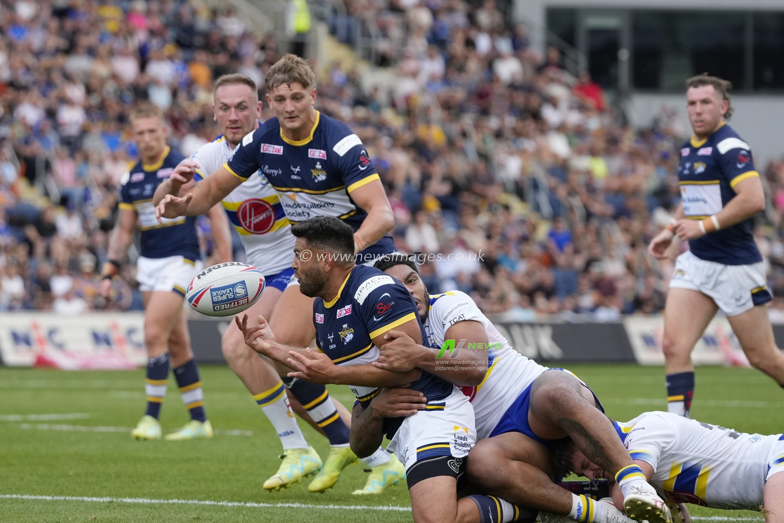 Rhyse Martin #12 of Leeds Rhinos offloads to Sam Walters #22 of Leeds Rhinos during the Betfred Super League Round 22 match Leeds Rhinos vs Warrington Wolves at Headingley Stadium, Leeds, United Kingdom, 20th August 2023

(Photo by Steve Flynn/News Images)