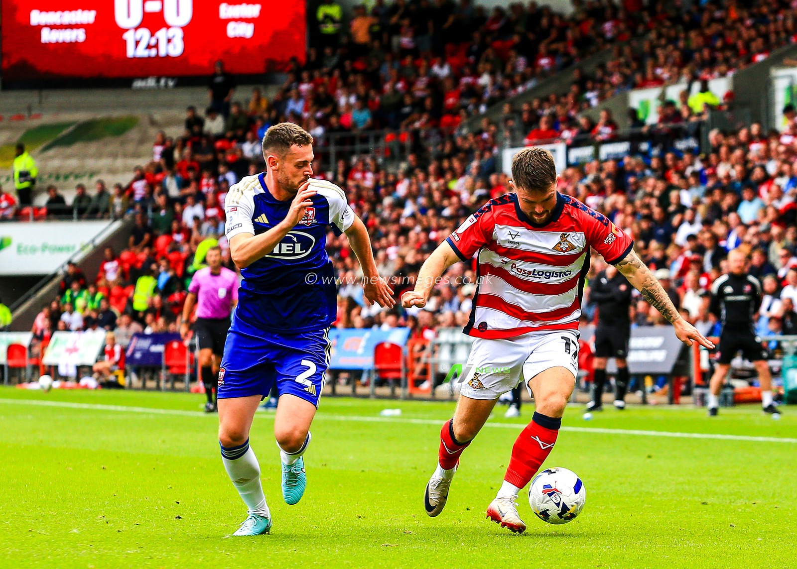 Jack McMillan of Exeter City adds pressure to Glenn Middleton of Doncaster Rovers during the Sky Bet League 1 match Doncaster Rovers vs Exeter City at Eco-Power Stadium, Doncaster, United Kingdom, 2nd August 2025

(Photo by Richard Bierton/News Images)
