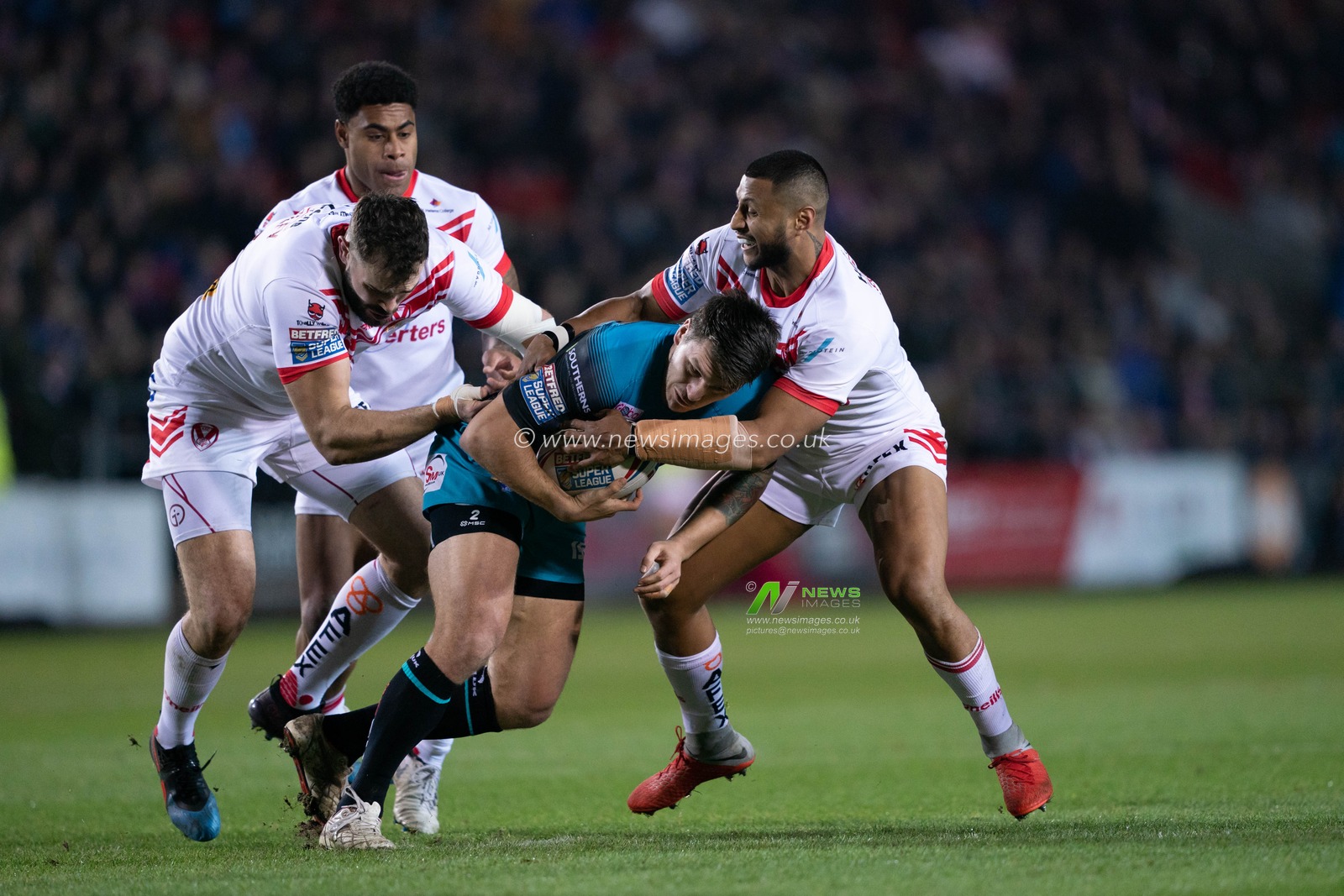 Leeds Rhinos's Tom Briscoe is tackled by  St. Helens's Alex Walmsley



22nd February 2019 , Totally Wicked Stadium, St Helens, England;  Betfred Super League, Round 3, St Helens vs Leeds Rhinos

Credit: Terry Donnelly/News Images
