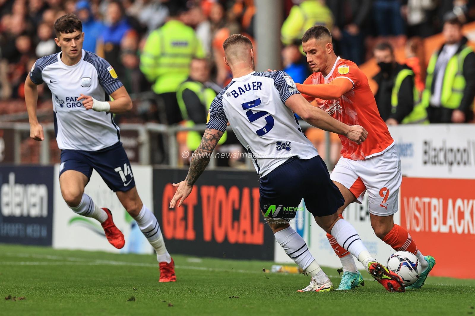 Jerry Yates #9 of Blackpool and Patrick Bauer #5 of Preston North End battle for the ball