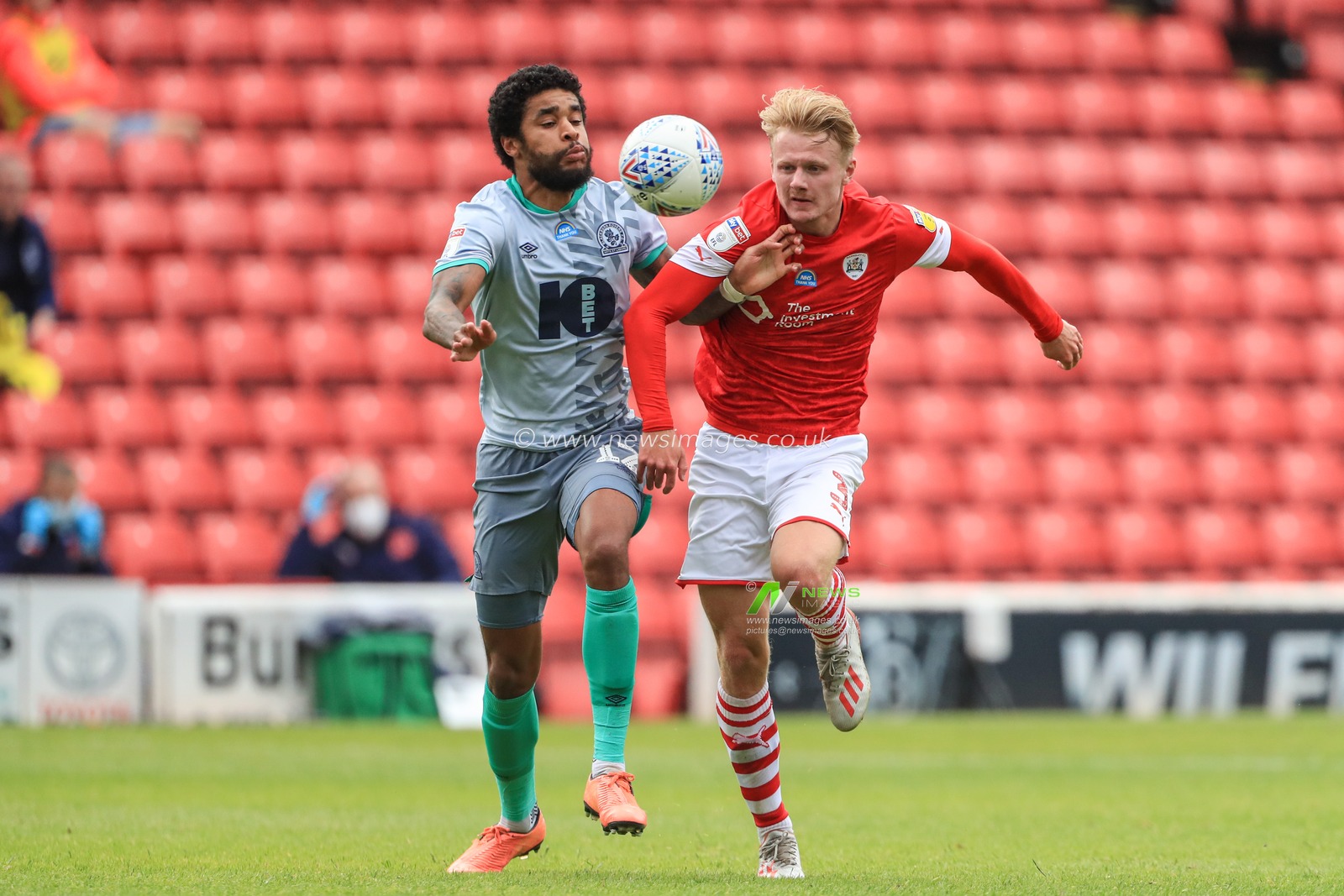 Ben Williams (3) of Barnsley and Dominic Samuel (12) of Blackburn Rovers dual for the ball