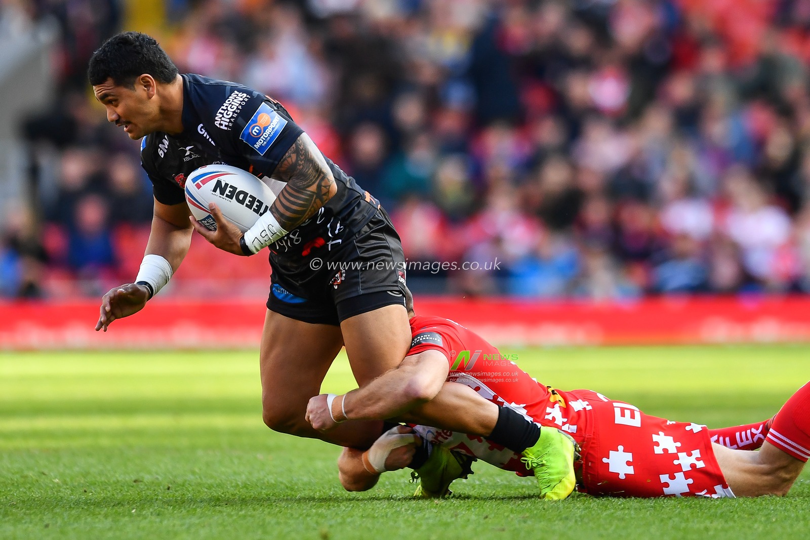 26th May 2019 , Anfield Stadium, Liverpool, England; Dacia Magic Weekend, Betfred Super League Round 16, St Helens vs Castleford Tigers ; Peter Mataâ€™utia (1) of Castleford Tigers is tackled by James Roby (9) of St Helens 

Credit: Craig Thomas/News Images