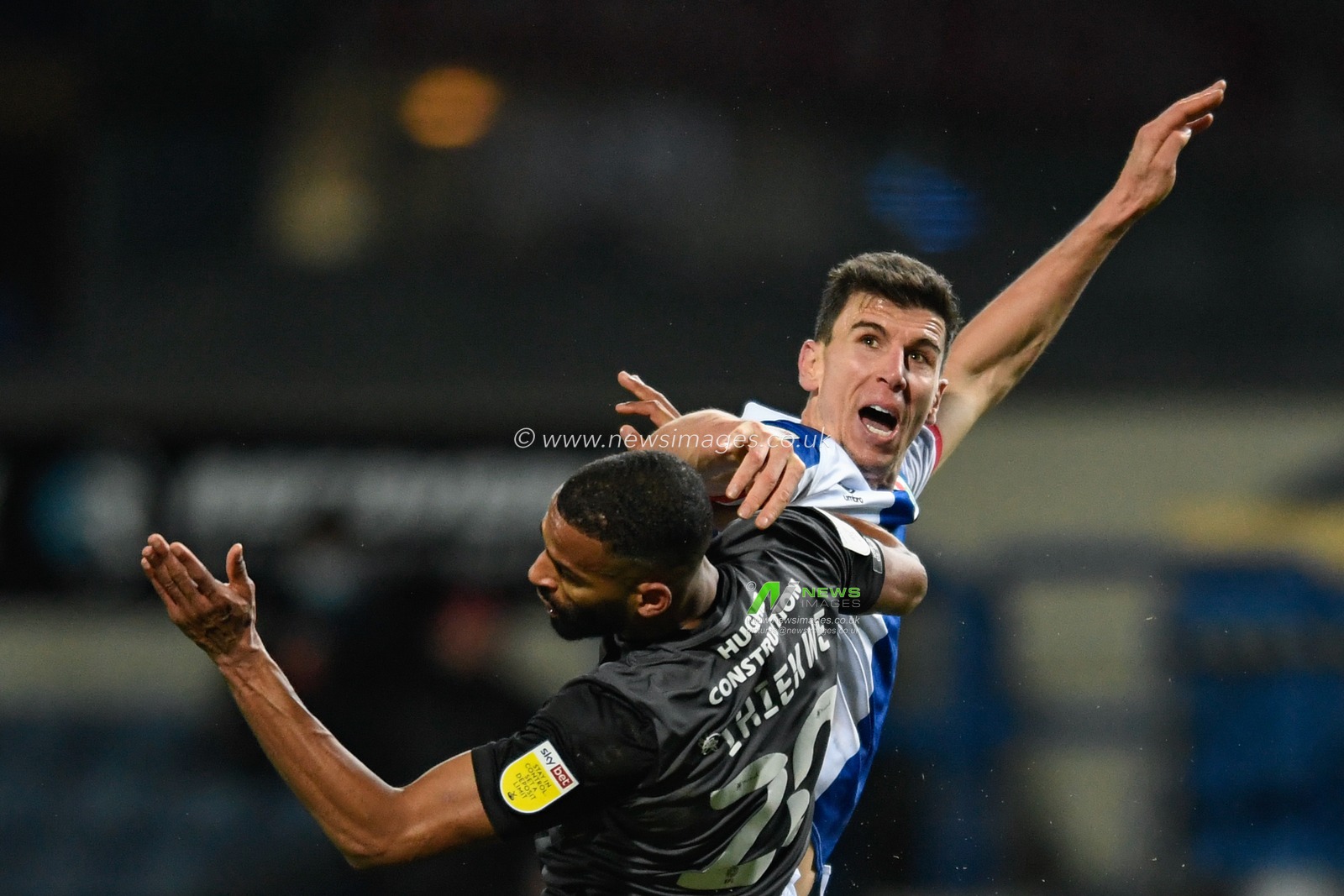 Daniel Ayala #5 of Blackburn Rovers and Michael Ihiekwe #20 of Rotherham United compete in the air