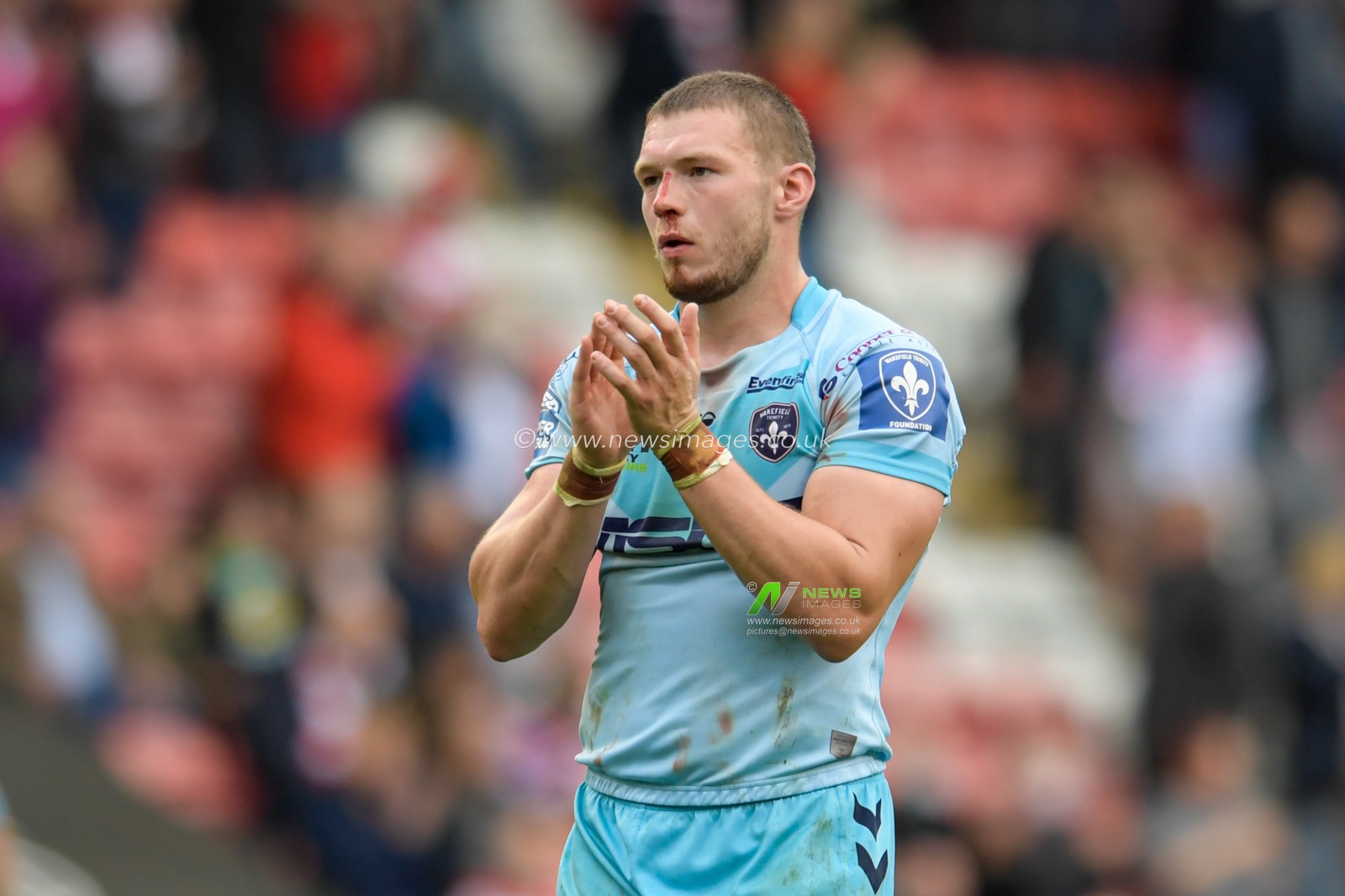 James Batchelor (16) of Wakefield Trinity applauds the travelling supporters at the end of the game
