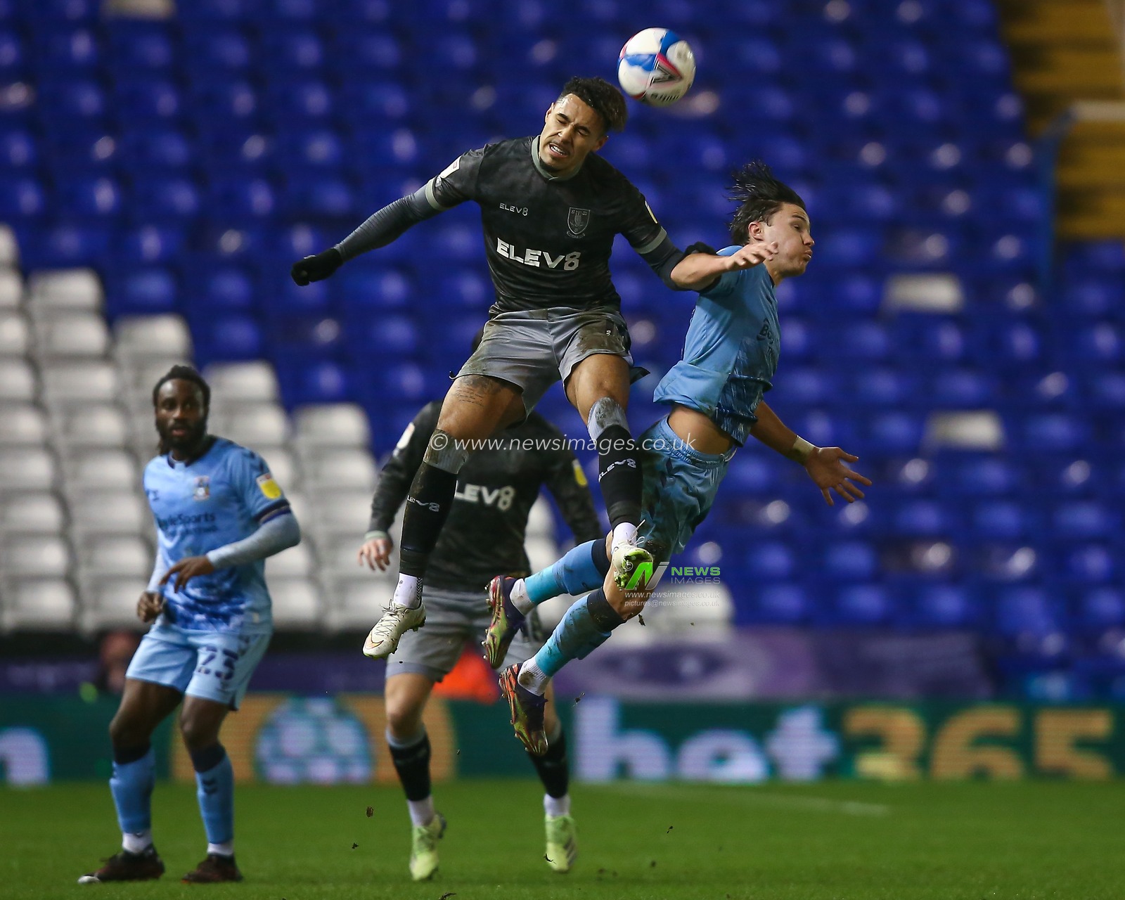 Callum OHare #11 of Coventry City and Andre Green #16 of Sheffield Wednesday compete for the aerial ball
