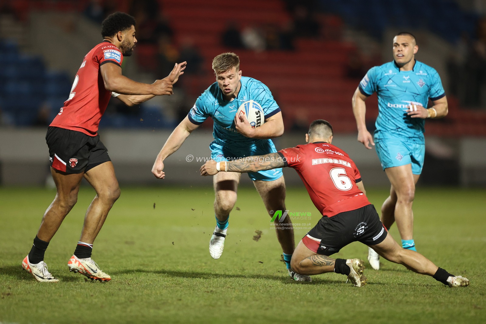 Harry Rushton of Huddersfield Giants is tackled by Kallum Watkins of Salford Red Devils and Jayden Nikorima of Salford Red Devils during the Betfred Super League Round 5 match Salford Red Devils vs Huddersfield Giants at Salford Community Stadium, Eccles, United Kingdom, 20th March 2025

(Photo by Alfie Cosgrove/News Images)