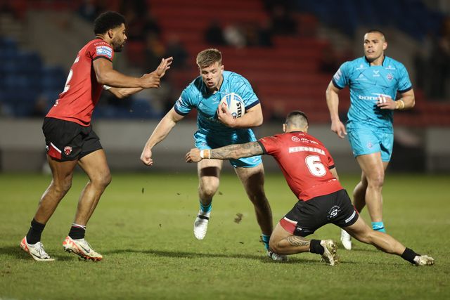 Harry Rushton of Huddersfield Giants is tackled by Kallum Watkins of Salford Red Devils and Jayden Nikorima of Salford Red Devils during the Betfred Super League Round 5 match Salford Red Devils vs Huddersfield Giants at Salford Community Stadium, Eccles, United Kingdom, 20th March 2025

(Photo by Alfie Cosgrove/News Images)