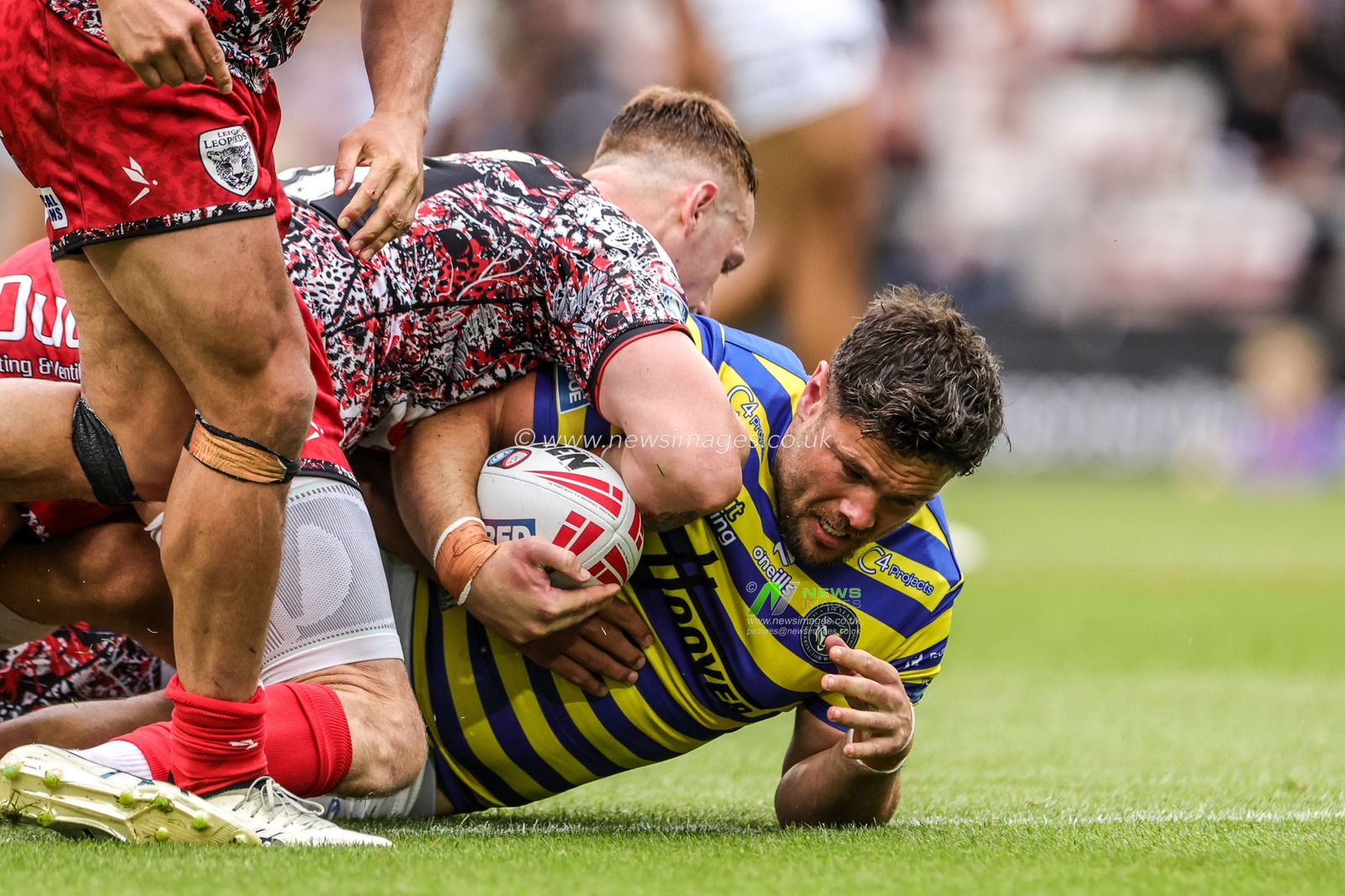 Joe Philbin of Warrington Wolves is tackled by Frankie Halton of Leigh Leopards during the Betfred Super League round 20 match Leigh Leopards vs Warrington Wolves at Leigh Sports Village, Leigh, United Kingdom on 25 July 2026

(Photo by Alfie Cosgrove/News Images)