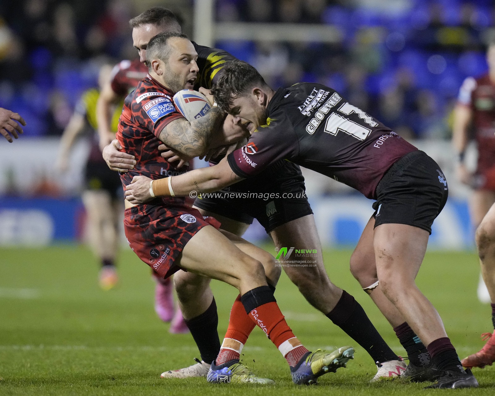 Jordy Crowther of Warrington Wolves and Ben Currie of Warrington Wolves tackle Gareth Oâ€™Brien of Leigh Leopards during the Rugby League Joe Philbin Testimonial match Warrington Wolves vs Leigh Leopards at Halliwell Jones Stadium, Warrington, United Kingdom, 3rd February 2024

(Photo by Steve Flynn/News Images)