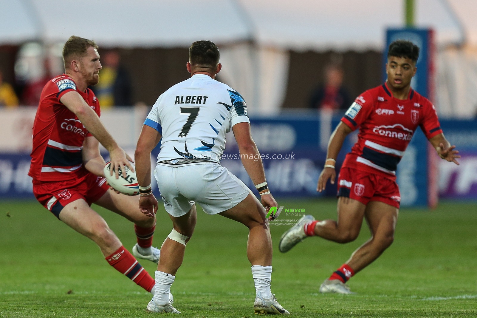 Rowan Milnes #21 of Hull KR looks to pass the ball to Phoenix Laulu-Togaga'e  #29 of Hull KR