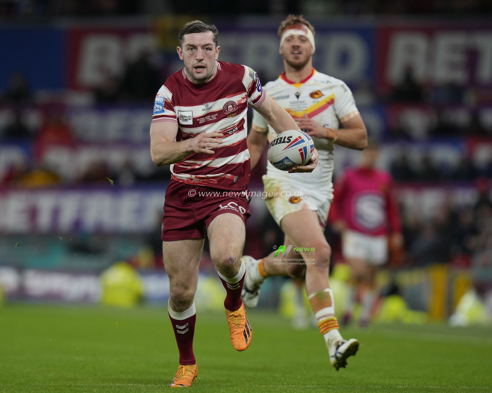 Jake Wardle #4 of Wigan Warriors makes a break past Paul Seguier #12 of Catalans Dragons during the Betfred Super League Grand Final match Wigan Warriors vs Catalans Dragons at Old Trafford, Manchester, United Kingdom, 14th October 2023

(Photo by Steve Flynn/News Images)