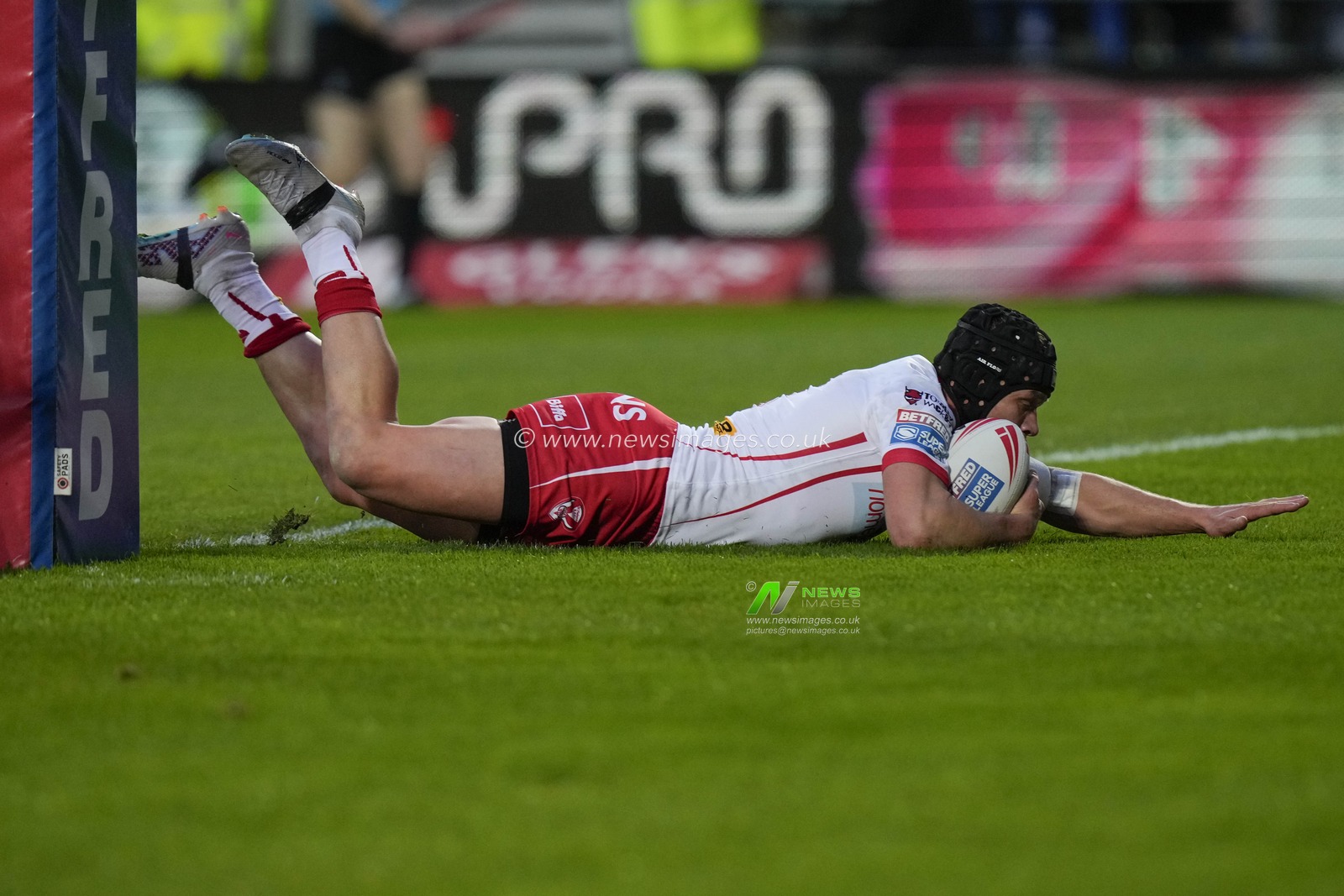 Jonny Lomax of St. Helens dives over the line to score a try during the Betfred Super League  Round 8 match St Helens vs Hull FC at Totally Wicked Stadium, St Helens, United Kingdom, 19th April 2024

(Photo by Steve Flynn/News Images)