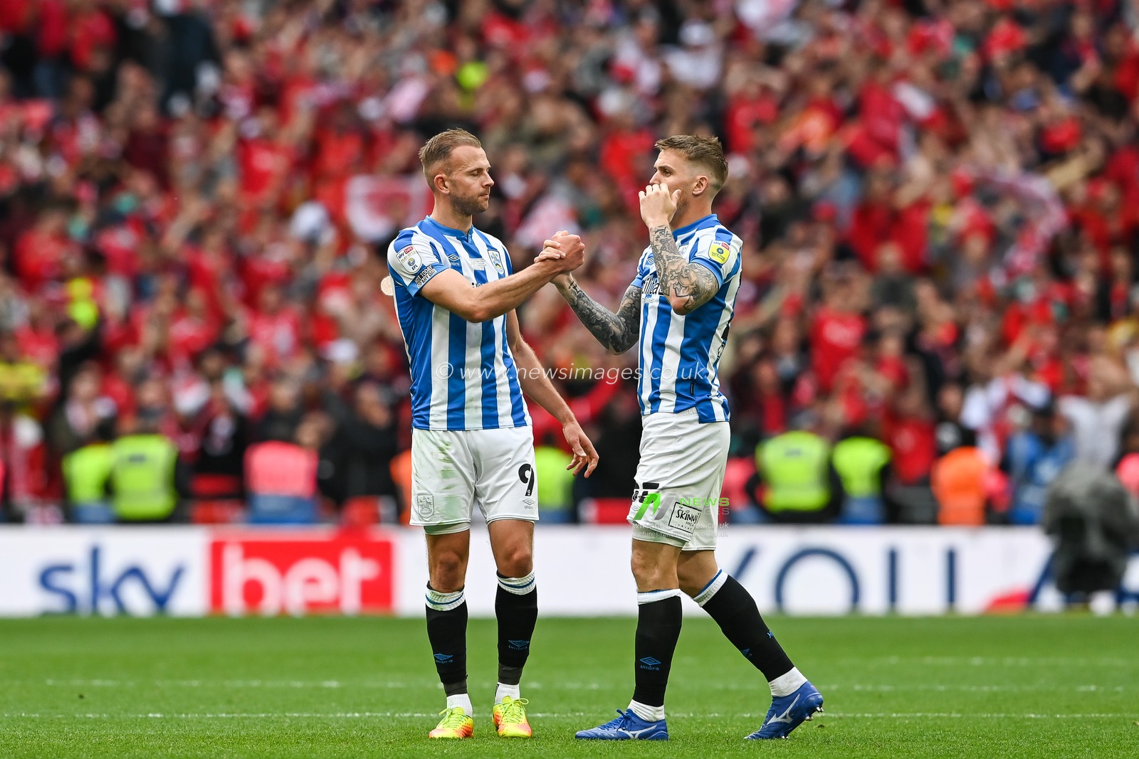 Jordan Rhodes #9 and Danny Ward #25 of Huddersfield Town shake hands at the end of the game