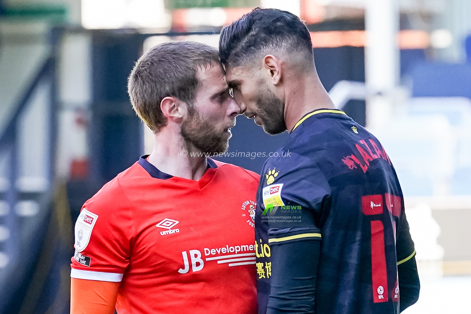 Jordan Clark #18 of Luton Town and Achraf Lazaar #17 of Watford square up