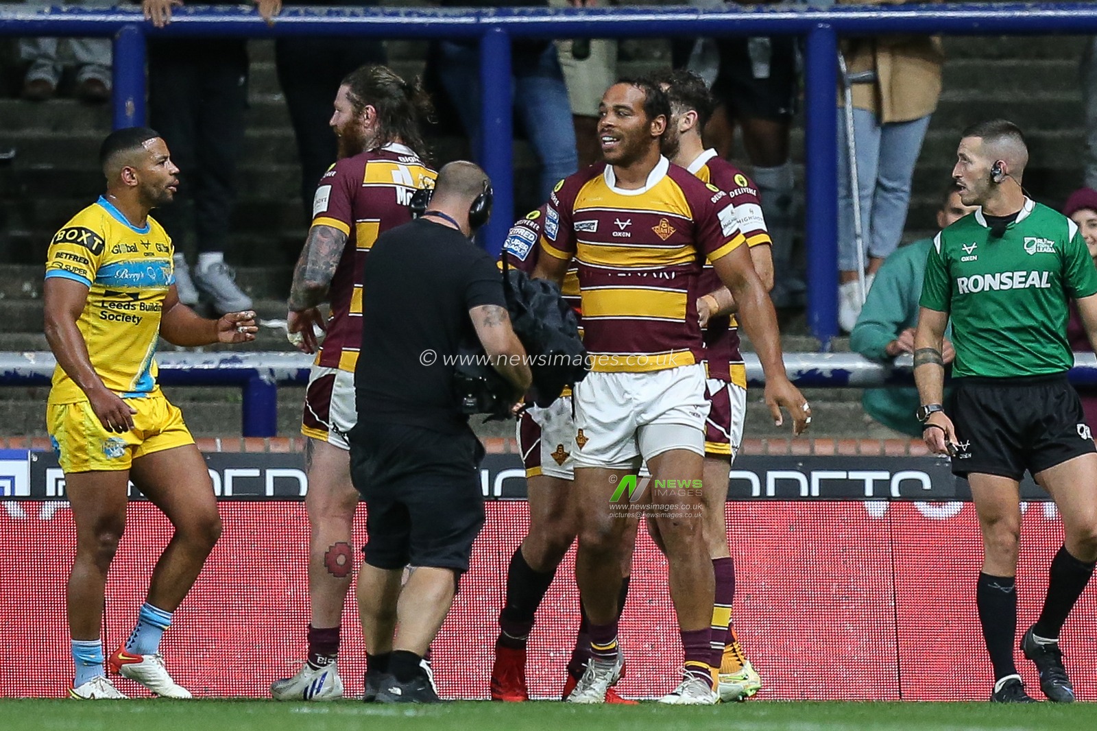Leroy Cudjoe #21 of Huddersfield Giants celebrates his try to make it 12-12