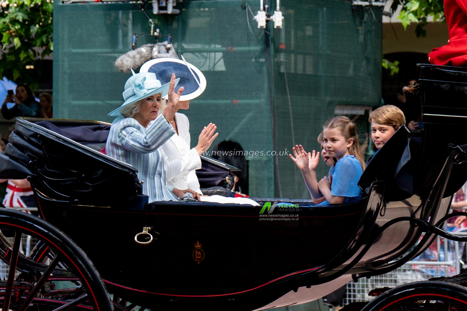 Camilla , Kate, George, Charlotte and Louis waving to the crowds in the mall
