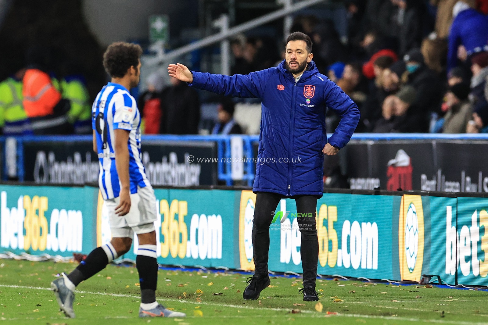 Carlos CorberÃ¡n manager of Huddersfield Town gives instructions to Duane Holmes #19 of Huddersfield Town