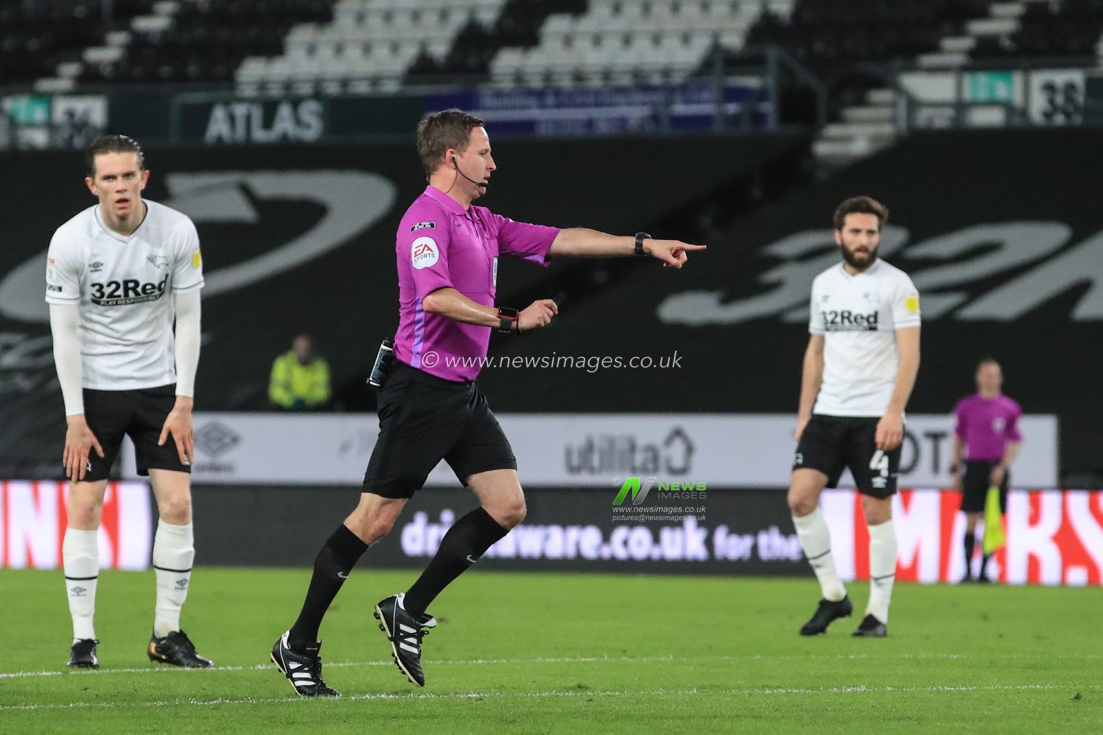 Referee David Webb points to the spot as Lee Buchanan #26 of Derby County brings down Bryan Mbeumo #19 of Brentford for a Brentford penalty