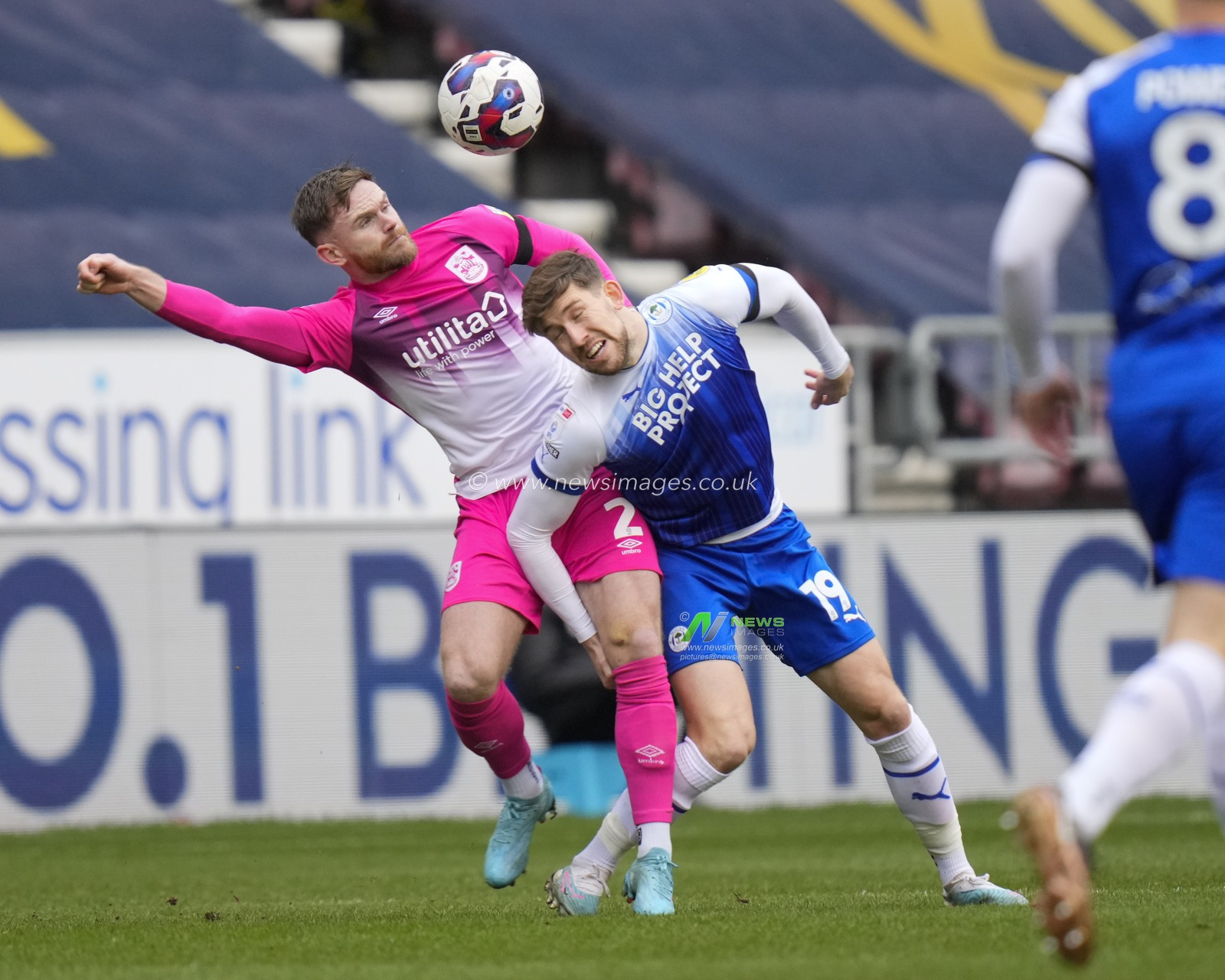 Callum Lang #19 of Wigan Athletic competes for a header with Oliver Turton #2 of Huddersfield Town during the Sky Bet Championship match Wigan Athletic vs Huddersfield Town at DW Stadium, Wigan, United Kingdom, 11th February 2023

(Photo by Steve Flynn/News Images)