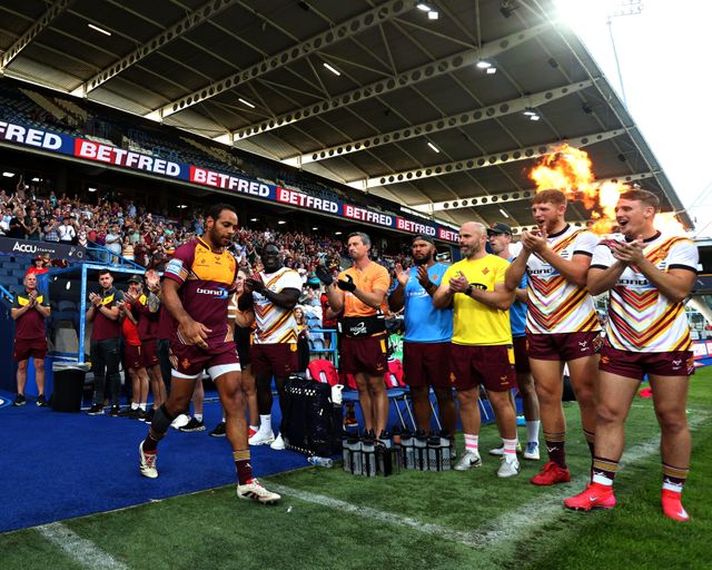 Leroy Cudjoe of Huddersfield Giants walks out to a guard of honour before the Betfred Super League round 19 match Huddersfield Giants vs Wakefield Trinity at the Accu Stadium, Huddersfield, United Kingdom, 18th July 2025

(Photo by Sam Eaden/News Images)