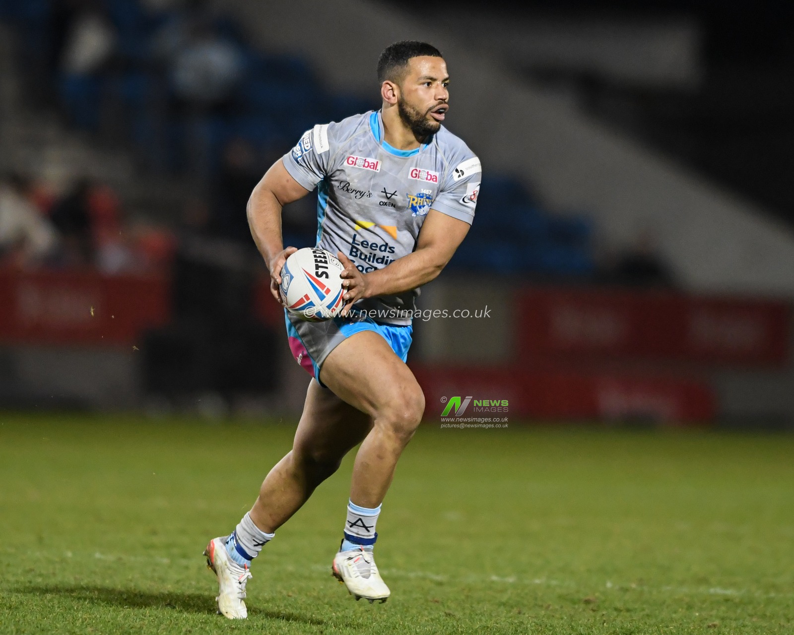 Kruise Leeming #9 of Leeds Rhinos runs forward with the ball