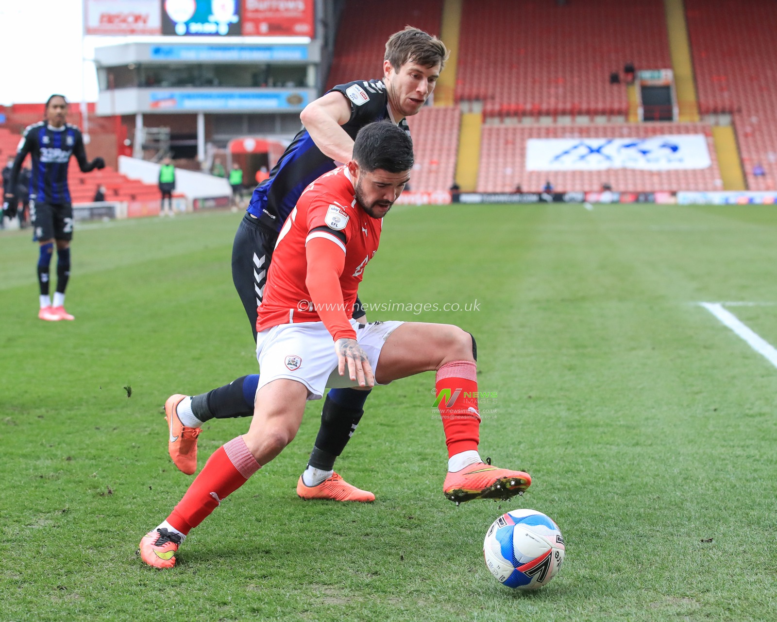 Alex Mowatt #27 of Barnsley holds off Paddy McNair #17 of Middlesbrough