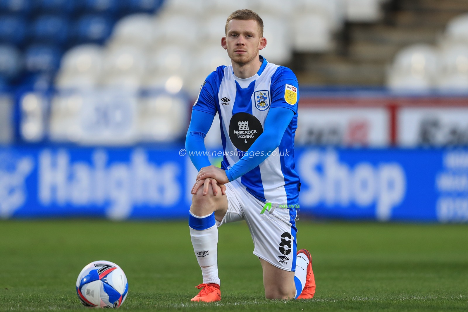 Lewis OBrien #8 of Huddersfield Town takes the knee