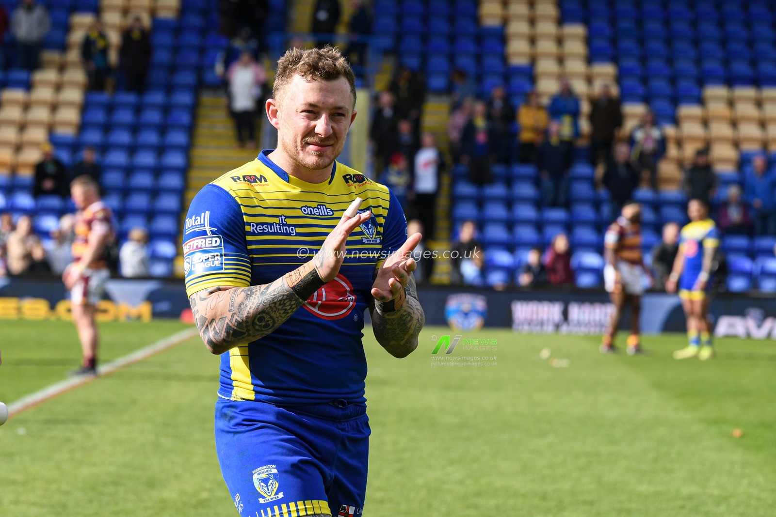 Josh Charnley #2 of Warrington Wolves applauds the home supporters at the end of the game after his side beat Huddersfield Giants 32-10