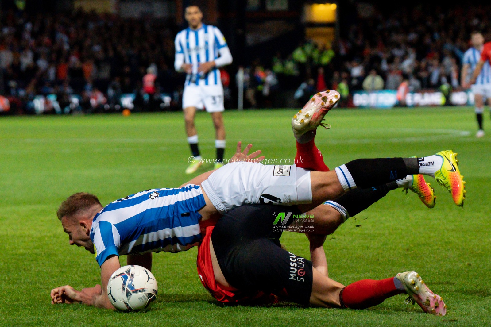 James Bree #2 of Luton Town battle for the ball Jordan Rhodes #9 of Huddersfield Town