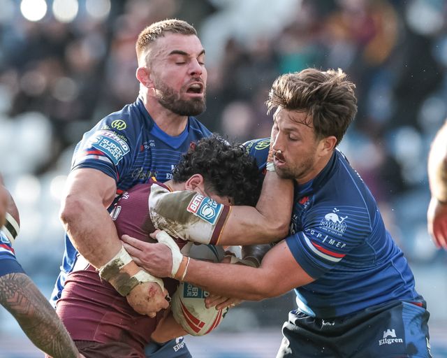 Jacob Gagai of Huddersfield Giants is tackled by Mike McMeeken and Zac Woolford of Huddersfield Giants during the Betfred Super League Round 2 match Huddersfield Giants vs Wakefield Trinity at Accu Stadium, Huddersfield, United Kingdom on 22 February 2026

(Photo by Mark Cosgrove/News Images)