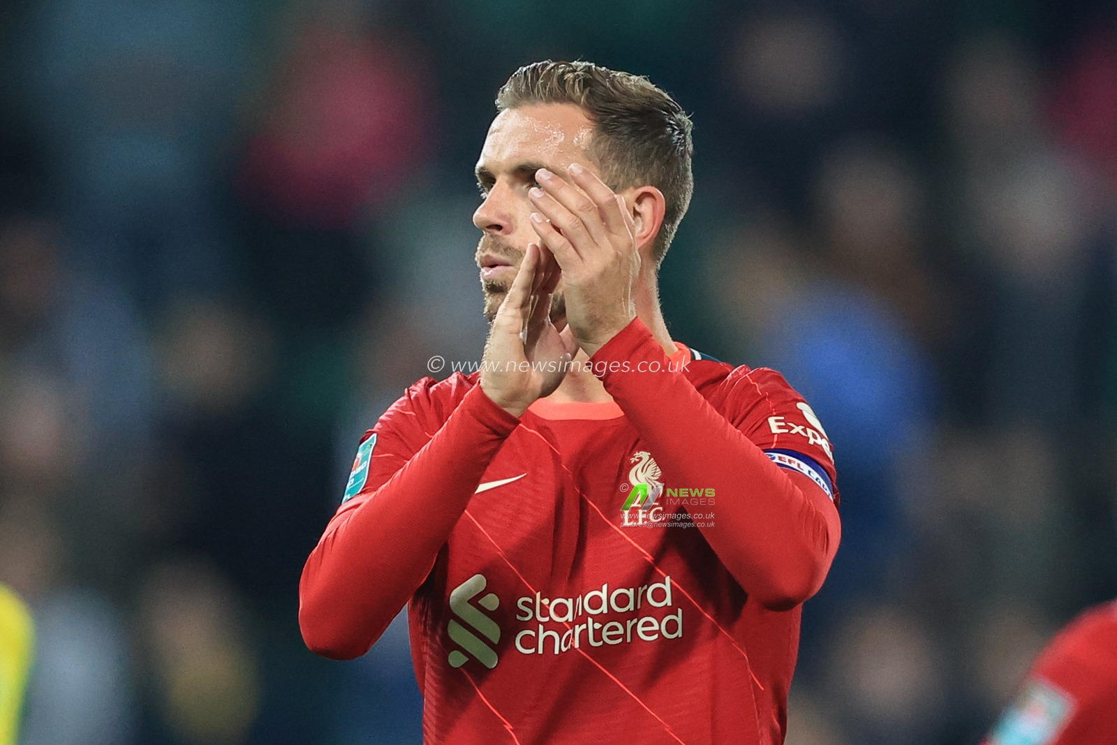 Jordan Henderson #14 of Liverpool applauds the traveling fans as Liverpool win 0-3