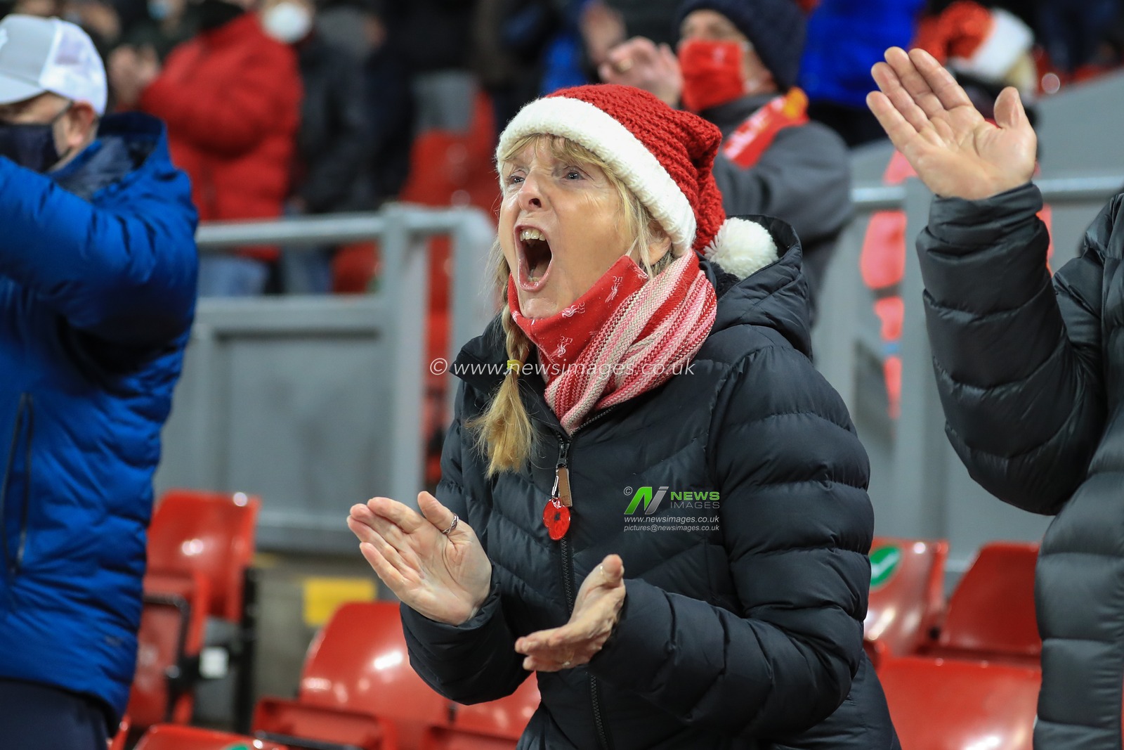 A Liverpool fan sings and claps as Liverpool come out for kick-off